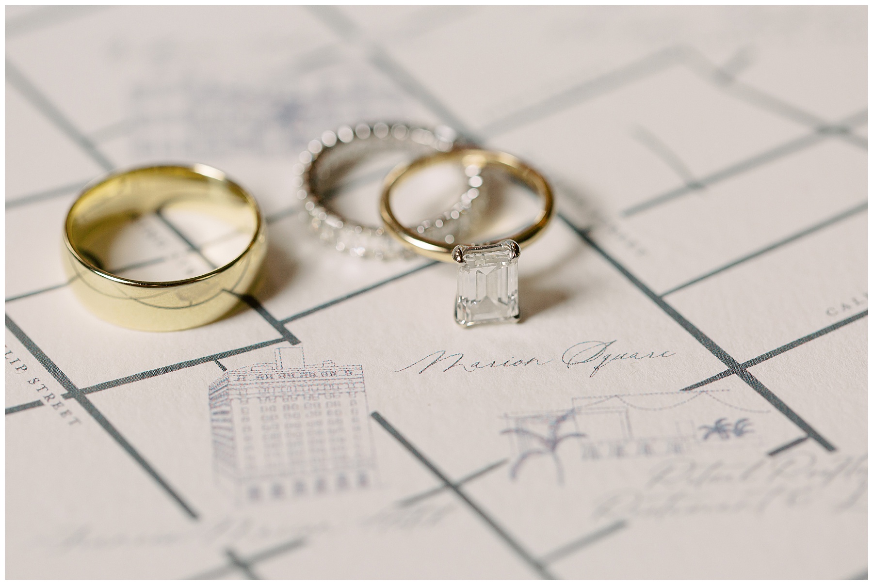 wedding bands lay on map of Charleston in invitation suite for SC wedding