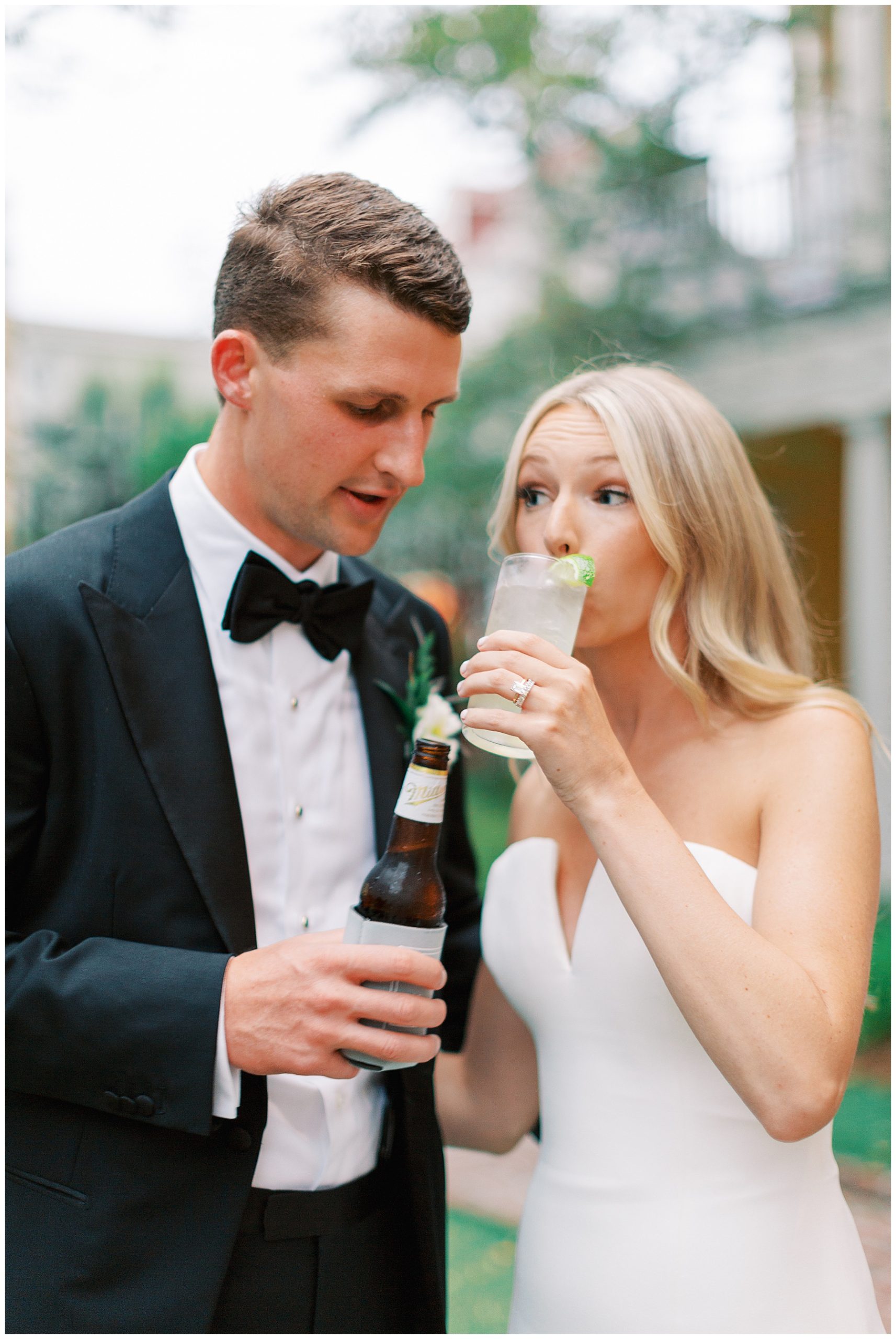 bride sips custom cocktail while groom grabs a beer in Charleston SC