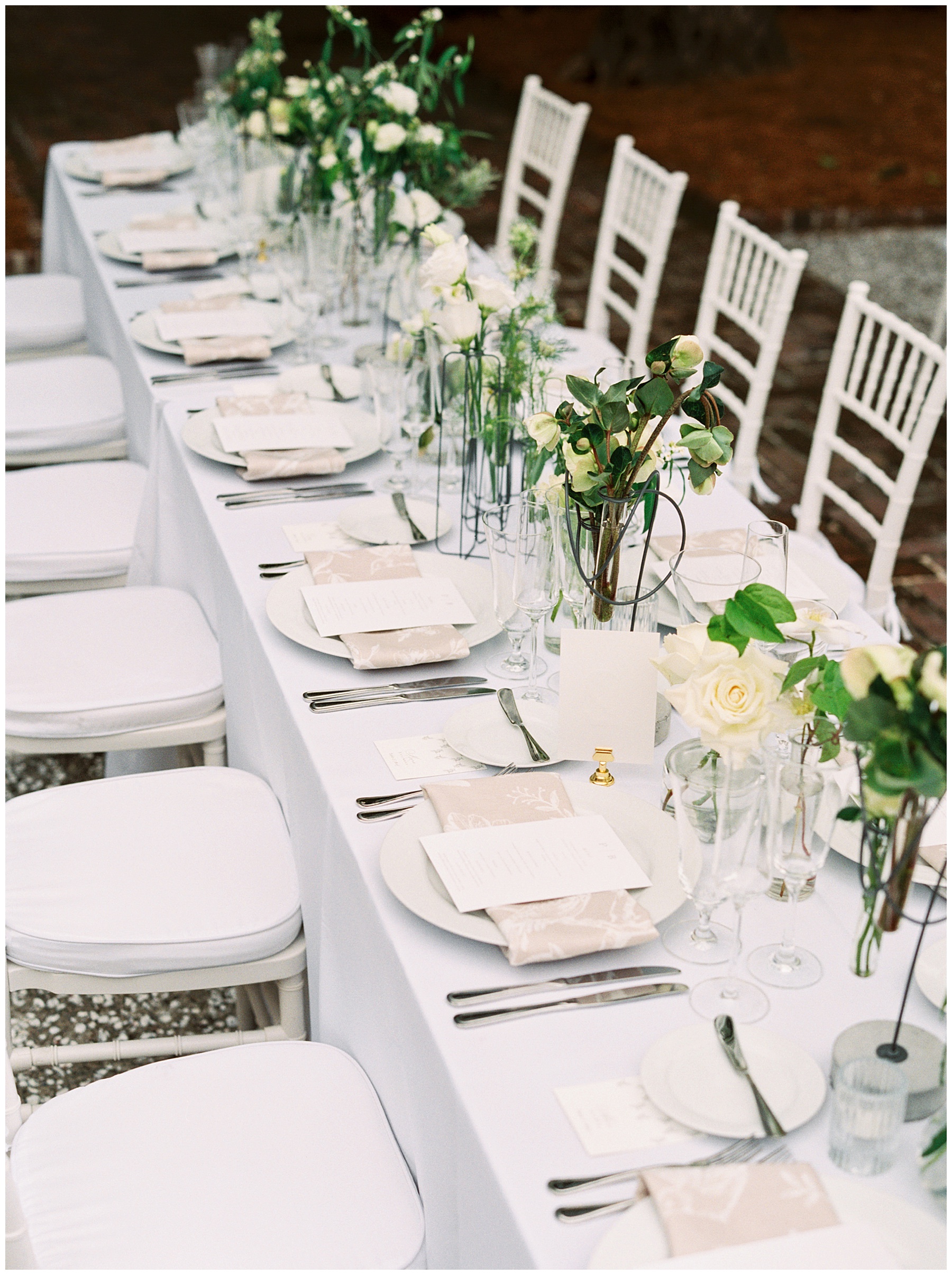 simple white rose centerpieces line table at the William Aiken House
