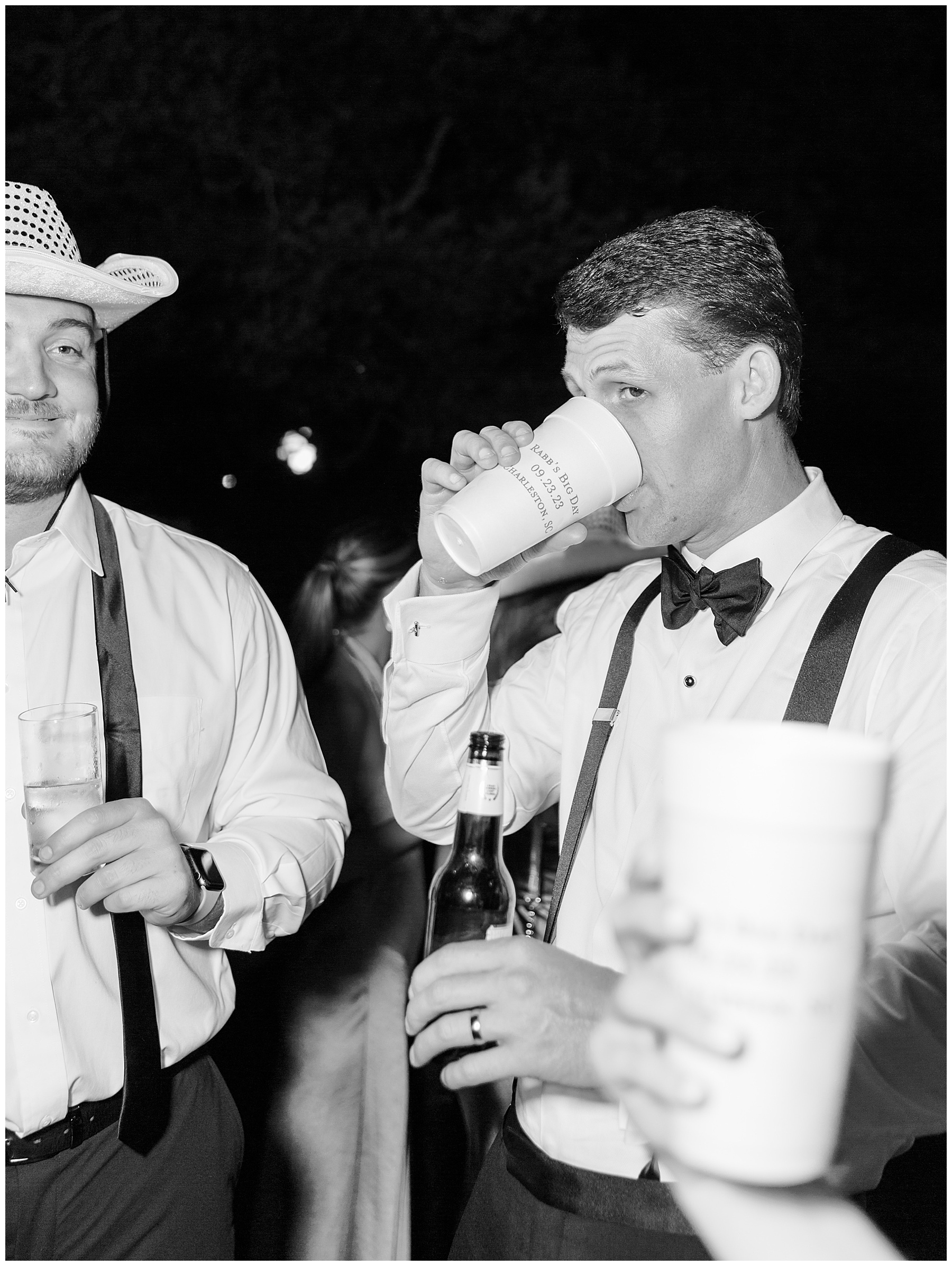 groom drinks out of custom cup on wedding night 