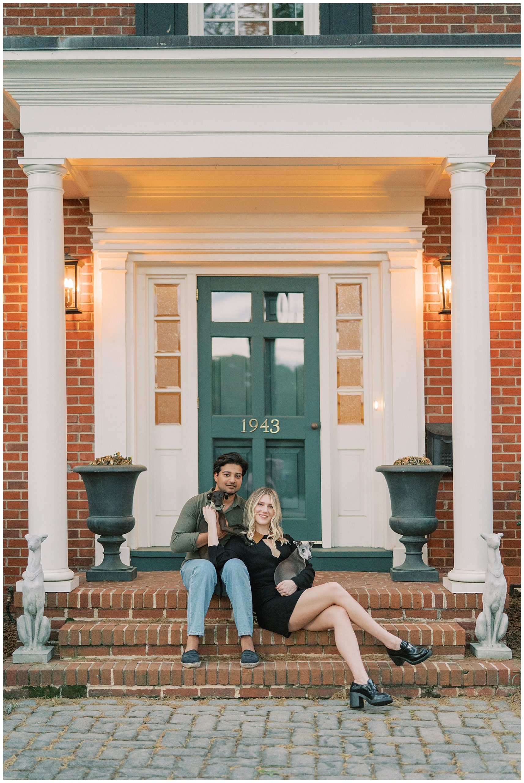 engaged couple sits on brick steps outside Duke Mansion front door