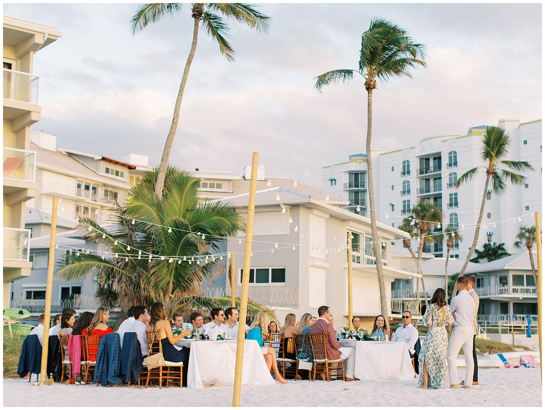 guests listen to toasts on beach during reception in Naples FL