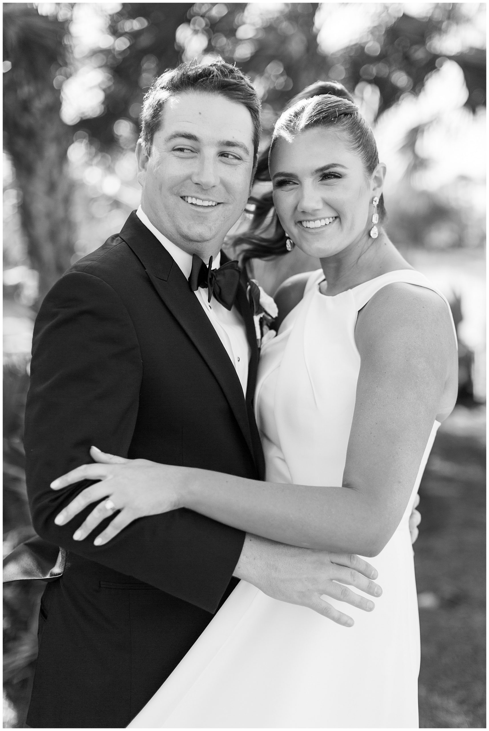 bride and groom hug during wedding photos in Naples FL