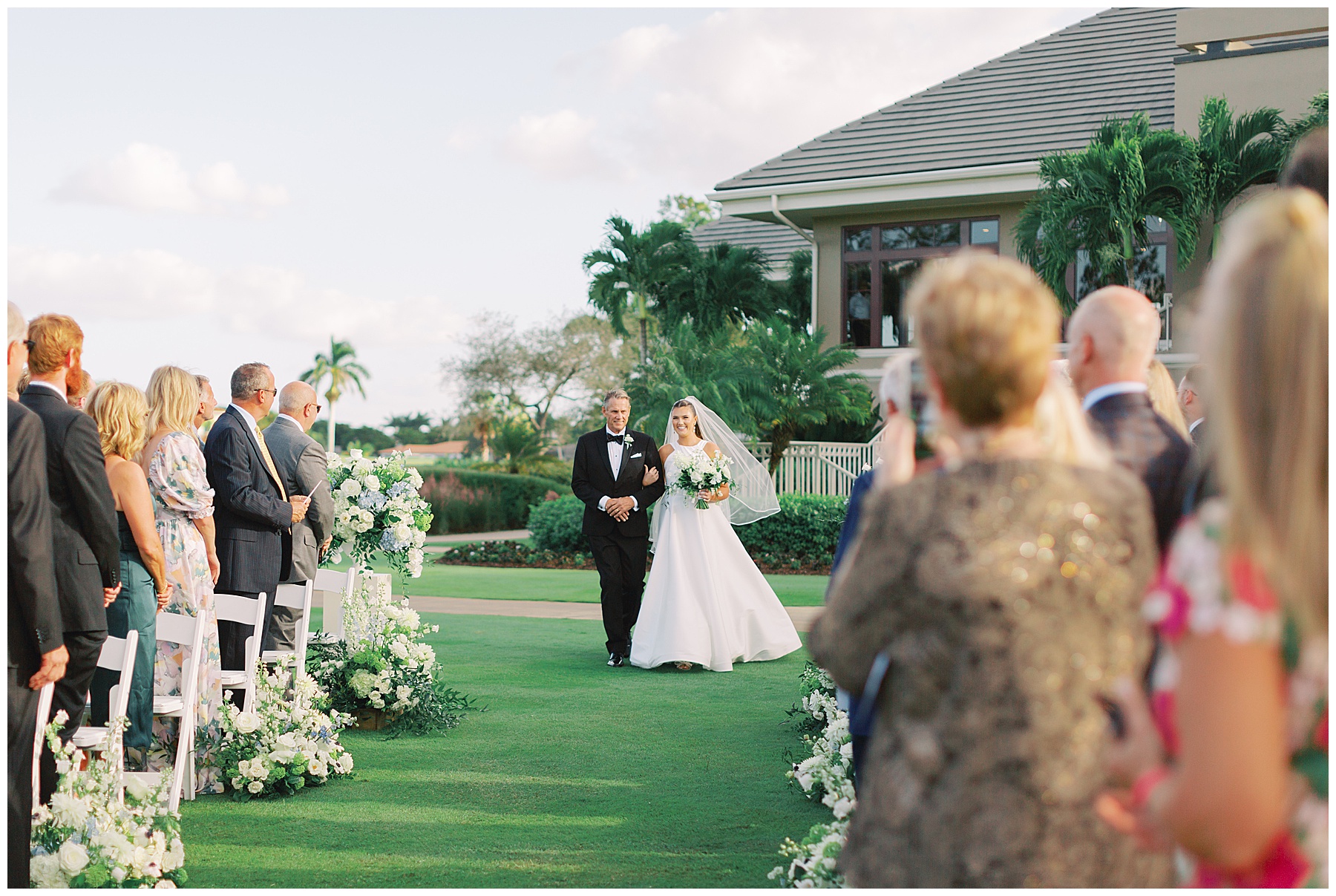 father escorts bride down aisle at Grey Oaks Country Club