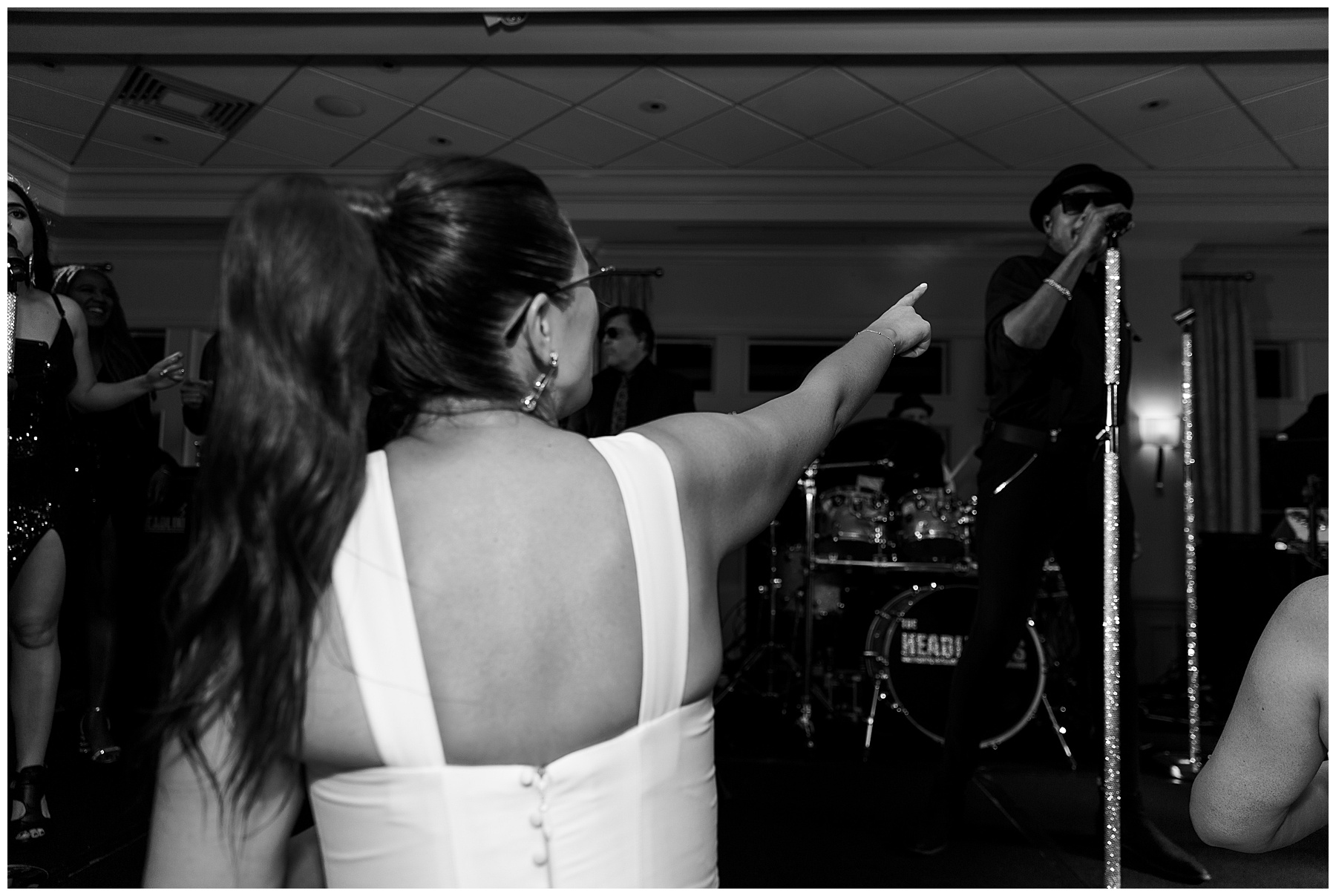 bride points at singer during reception in Naples FL country club