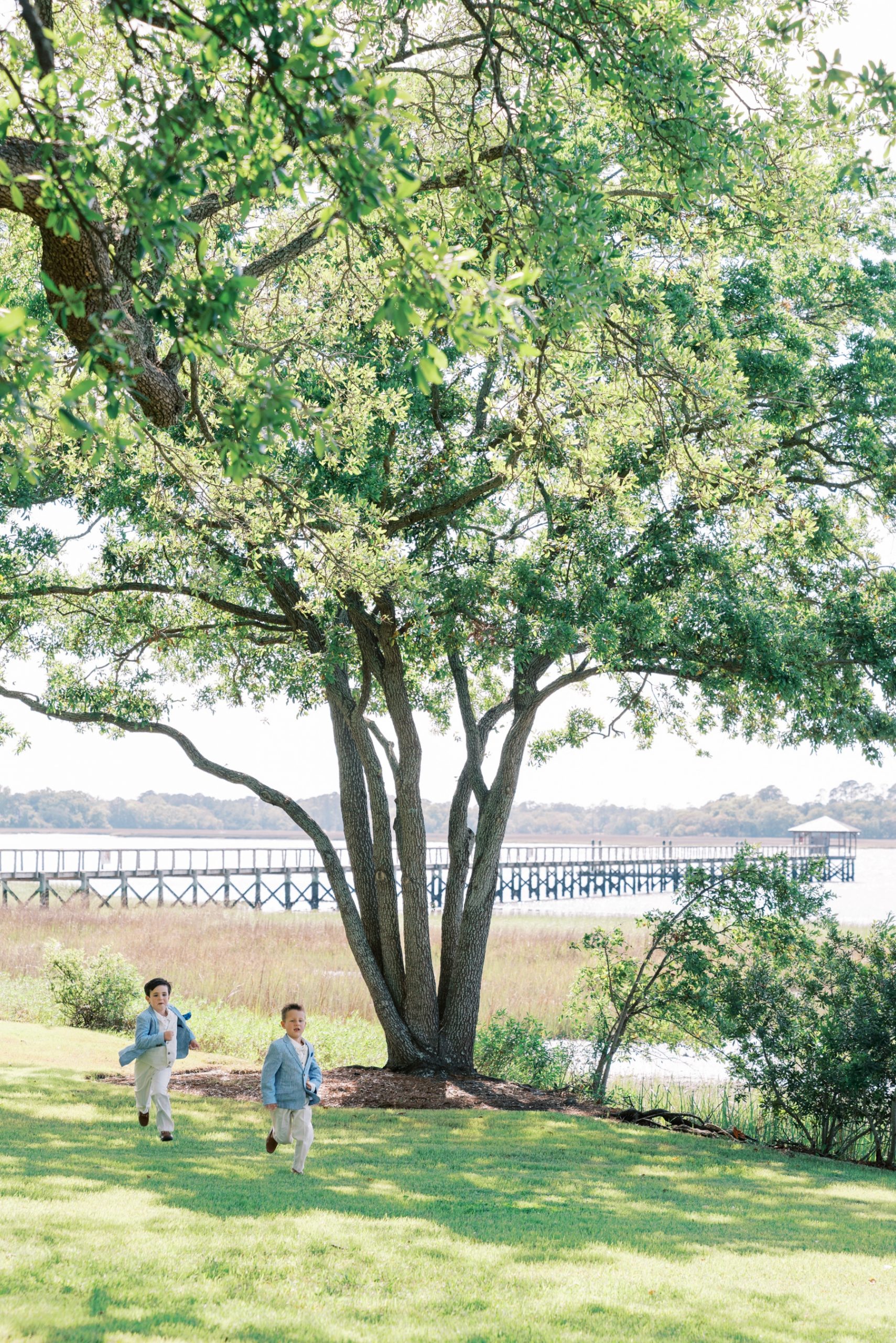 ring bearers running across lawn at Lowndes Grove