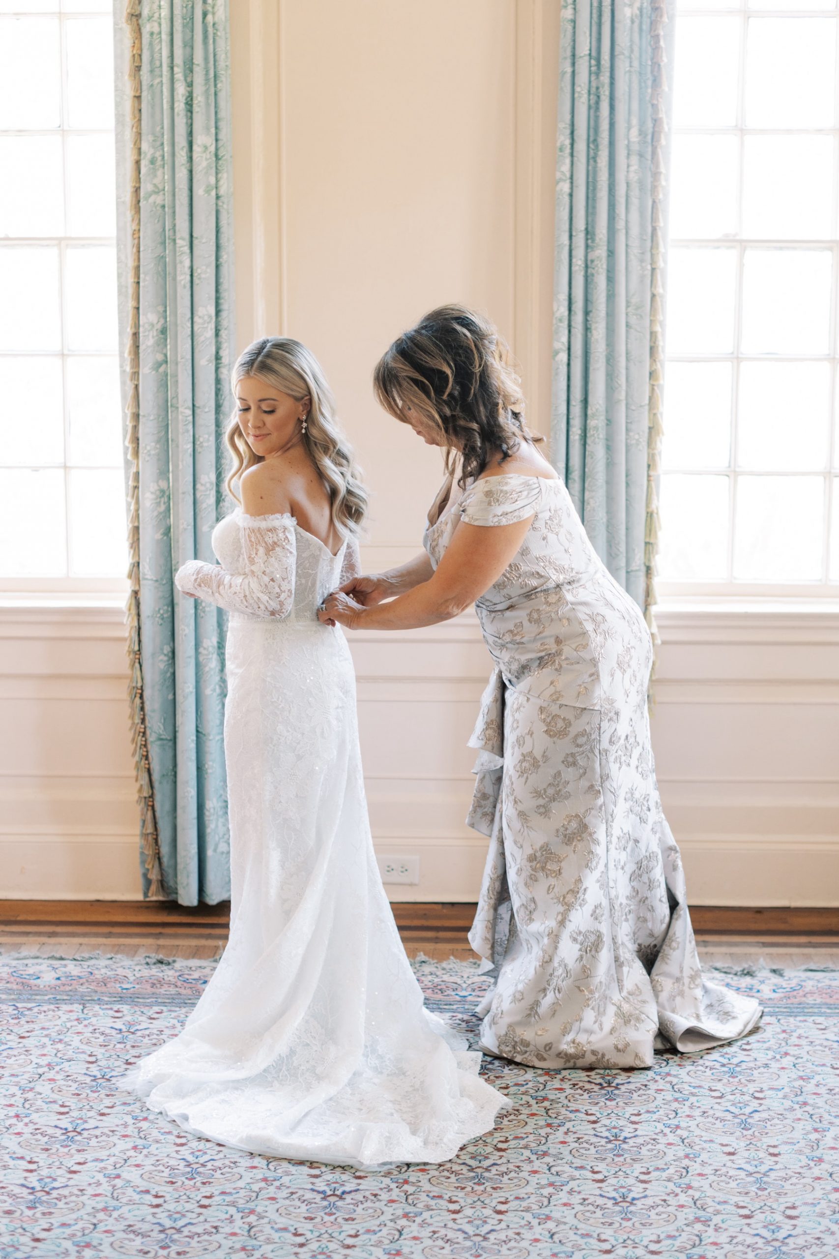Bride getting into wedding dress
