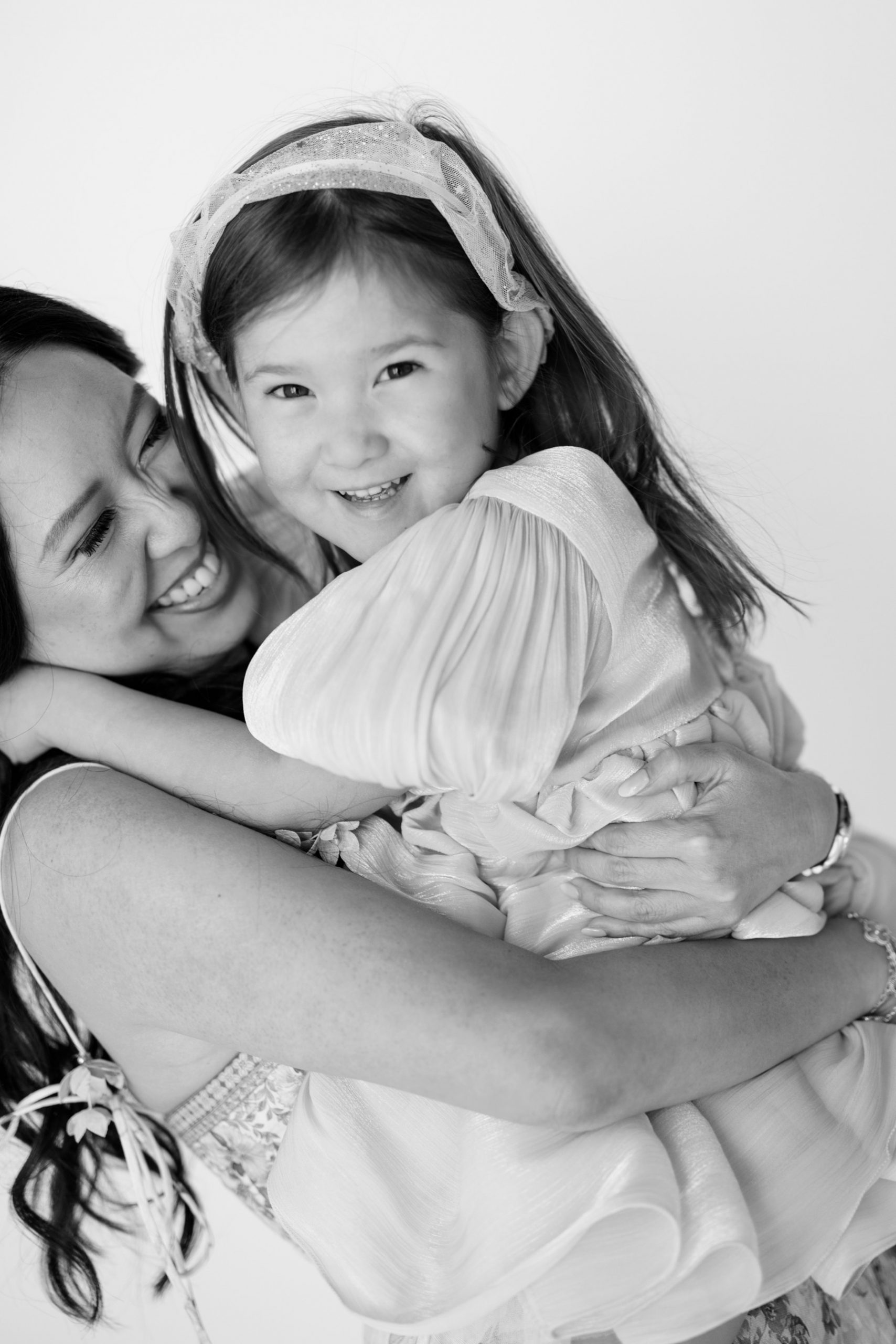 little girl hugs her mom