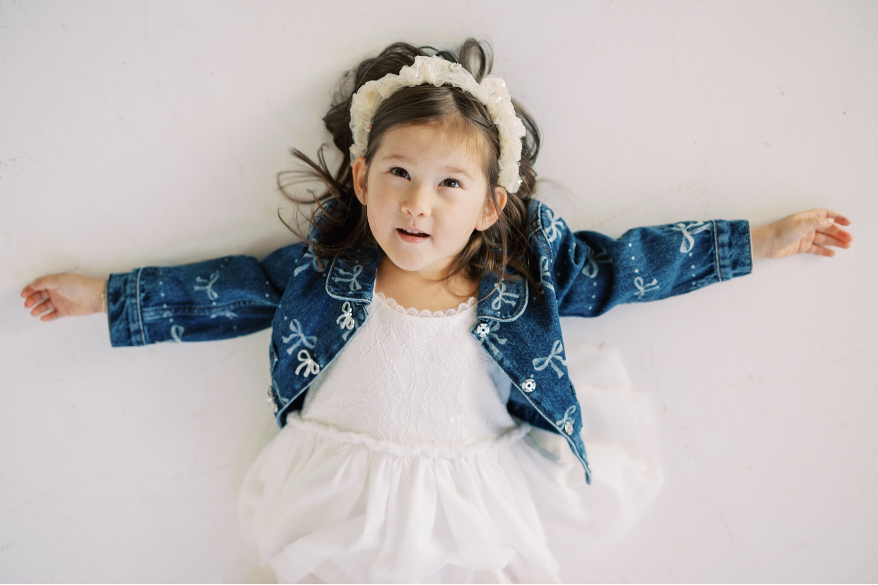 portraits of little girl in jean jacket
