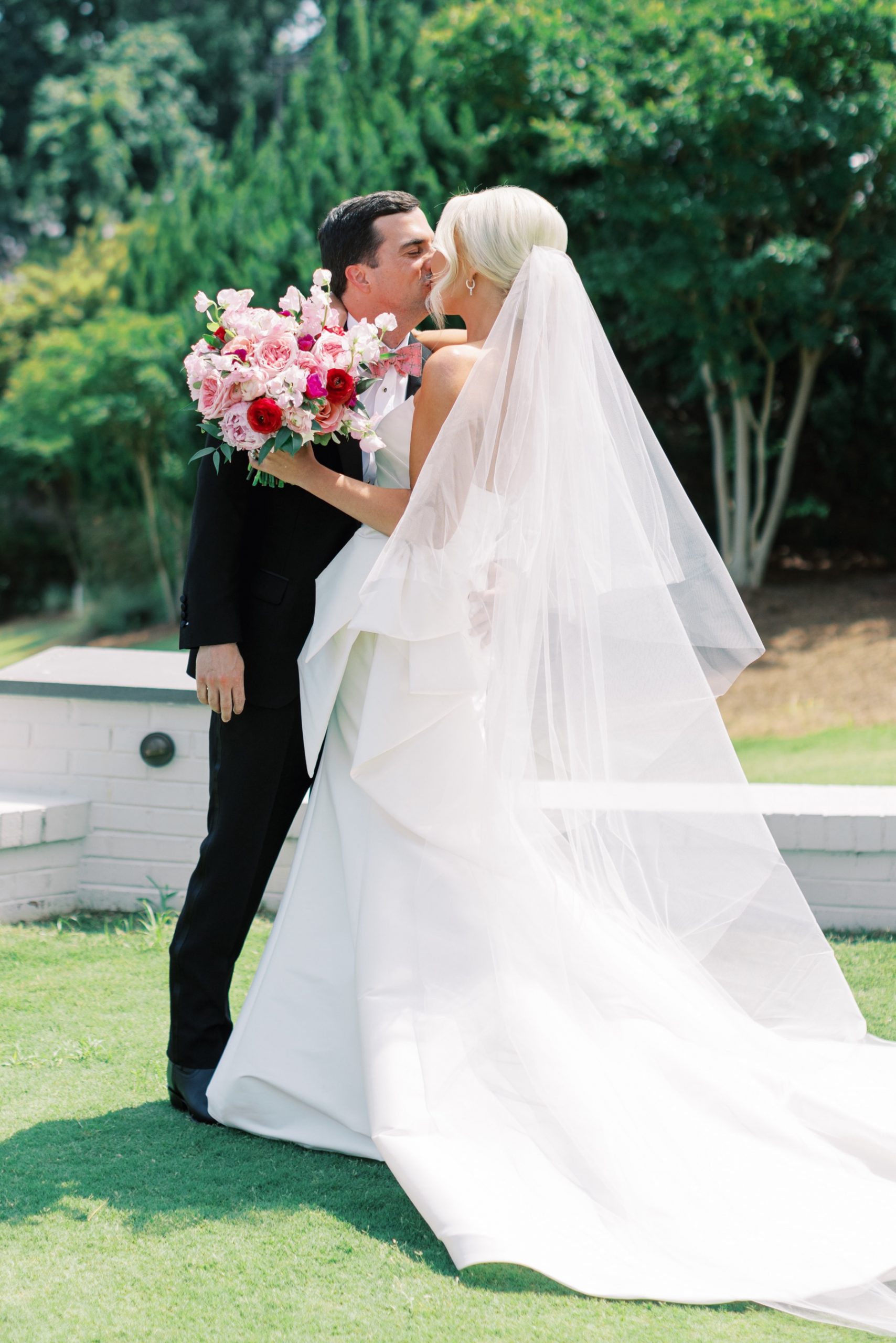 bride and groom kiss during first look