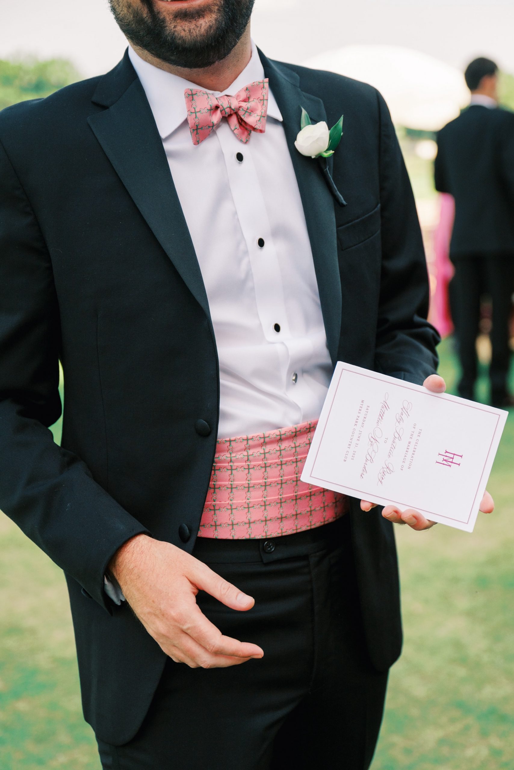Groomsmen holding wedding program
