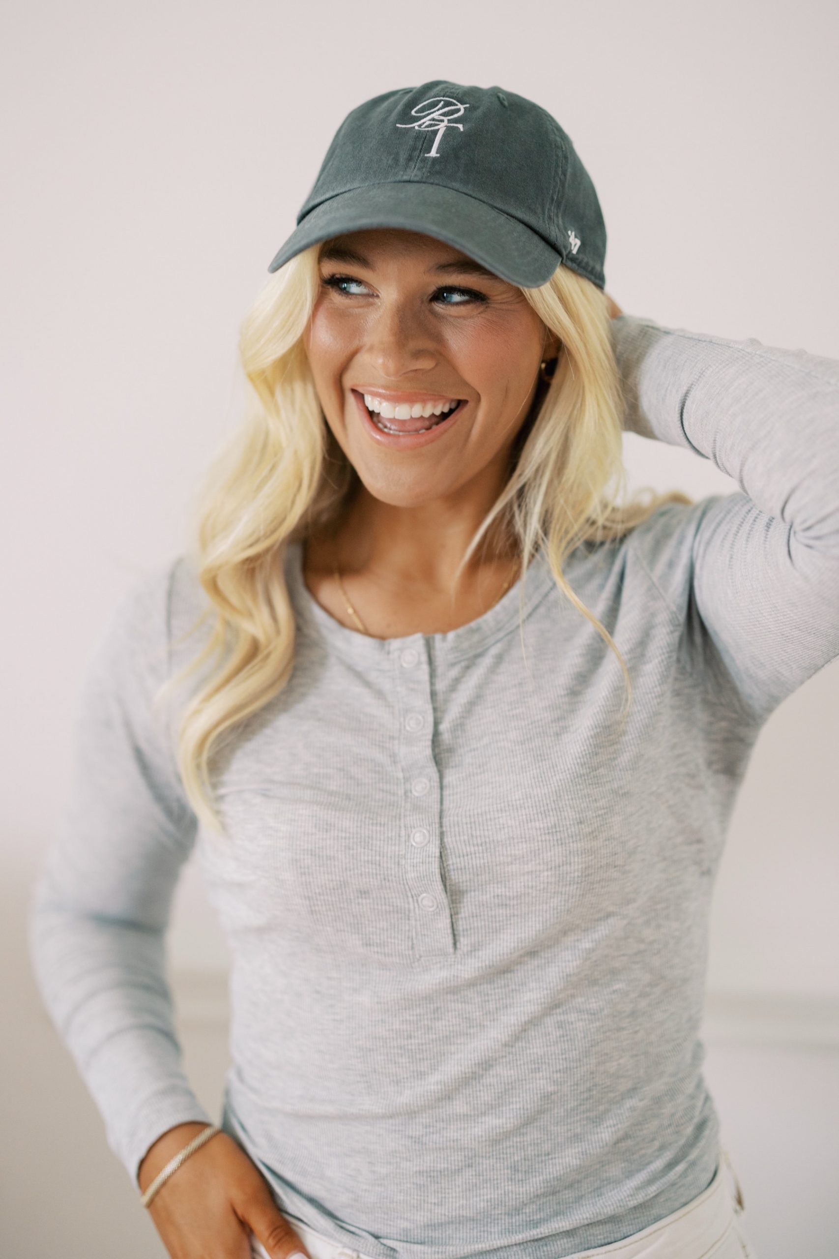 woman wearing hat with The Beauty Tribe logo