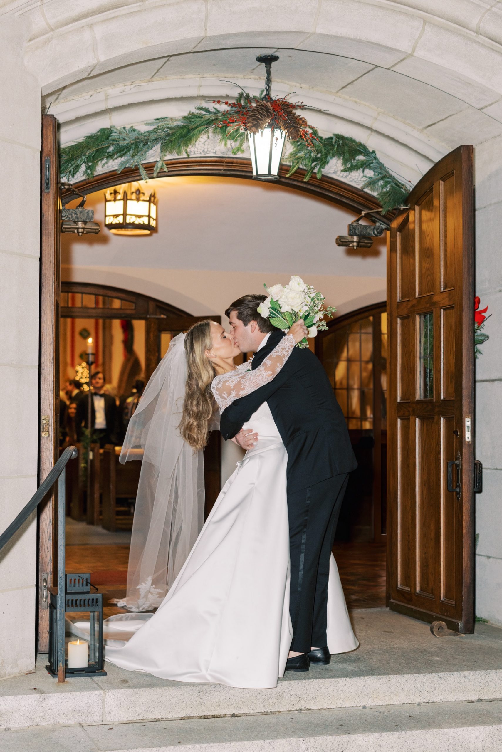 newlyweds kiss in church doorway
