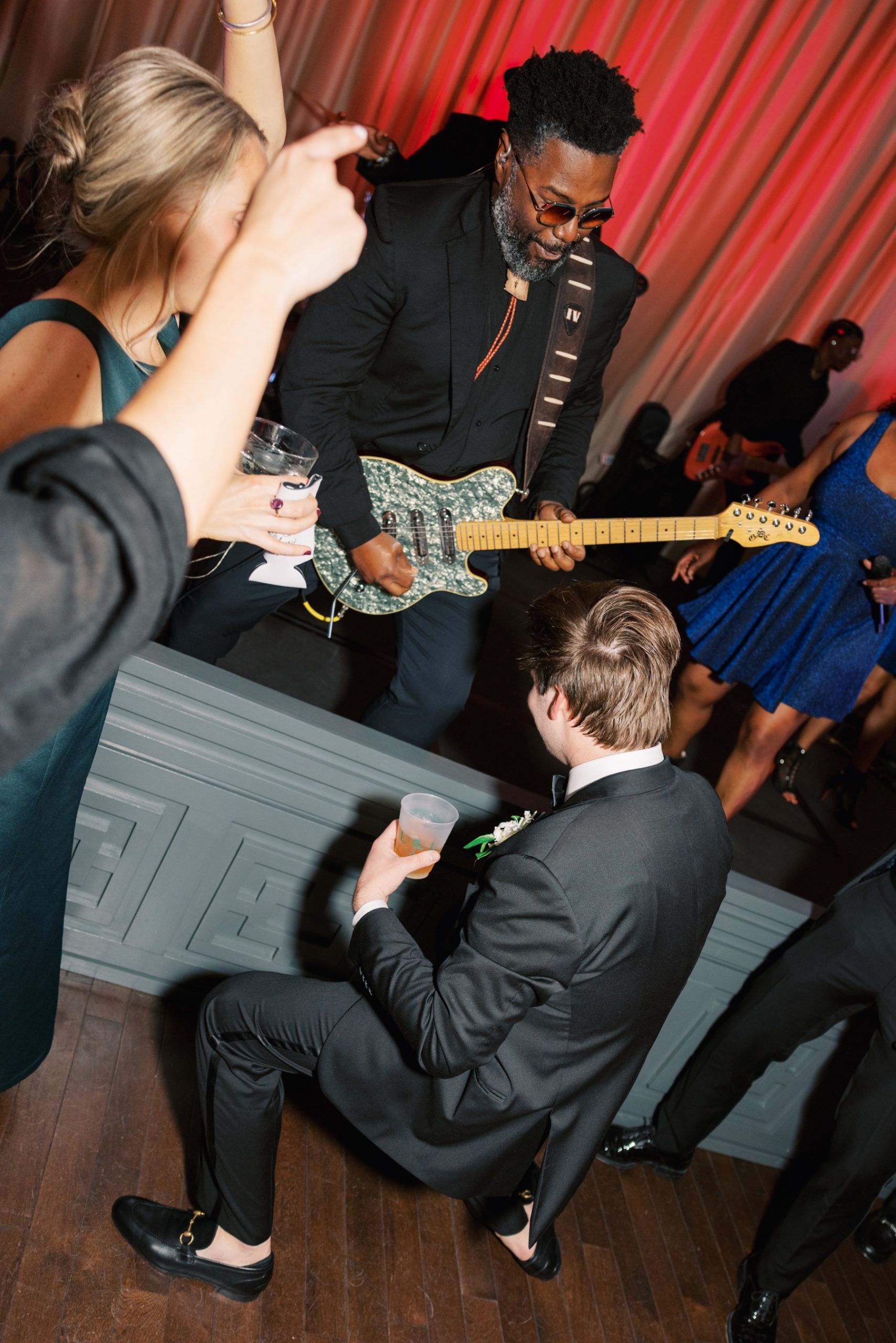wedding guests dance at reception 