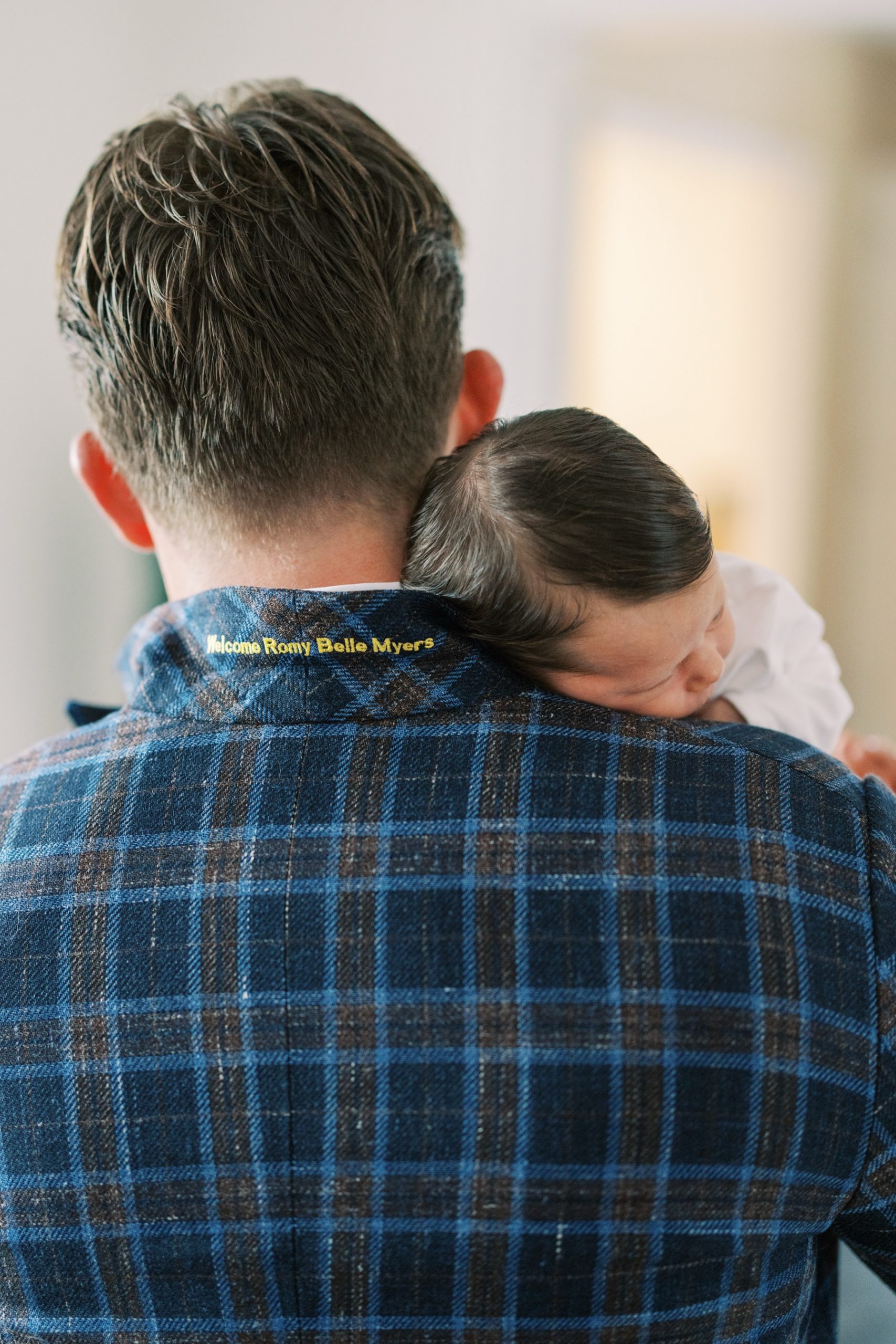 newborn baby resting on dad's shoulder at newborn session