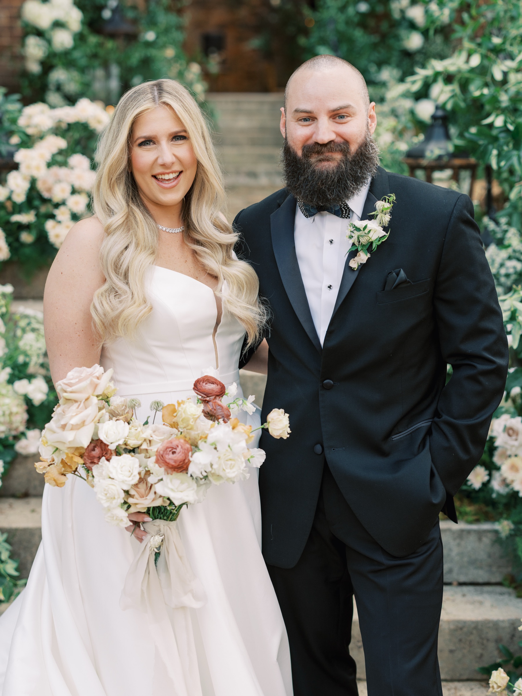 Close up of bride and groom with flowers in the background for their Fall Barnsley Resort Wedding