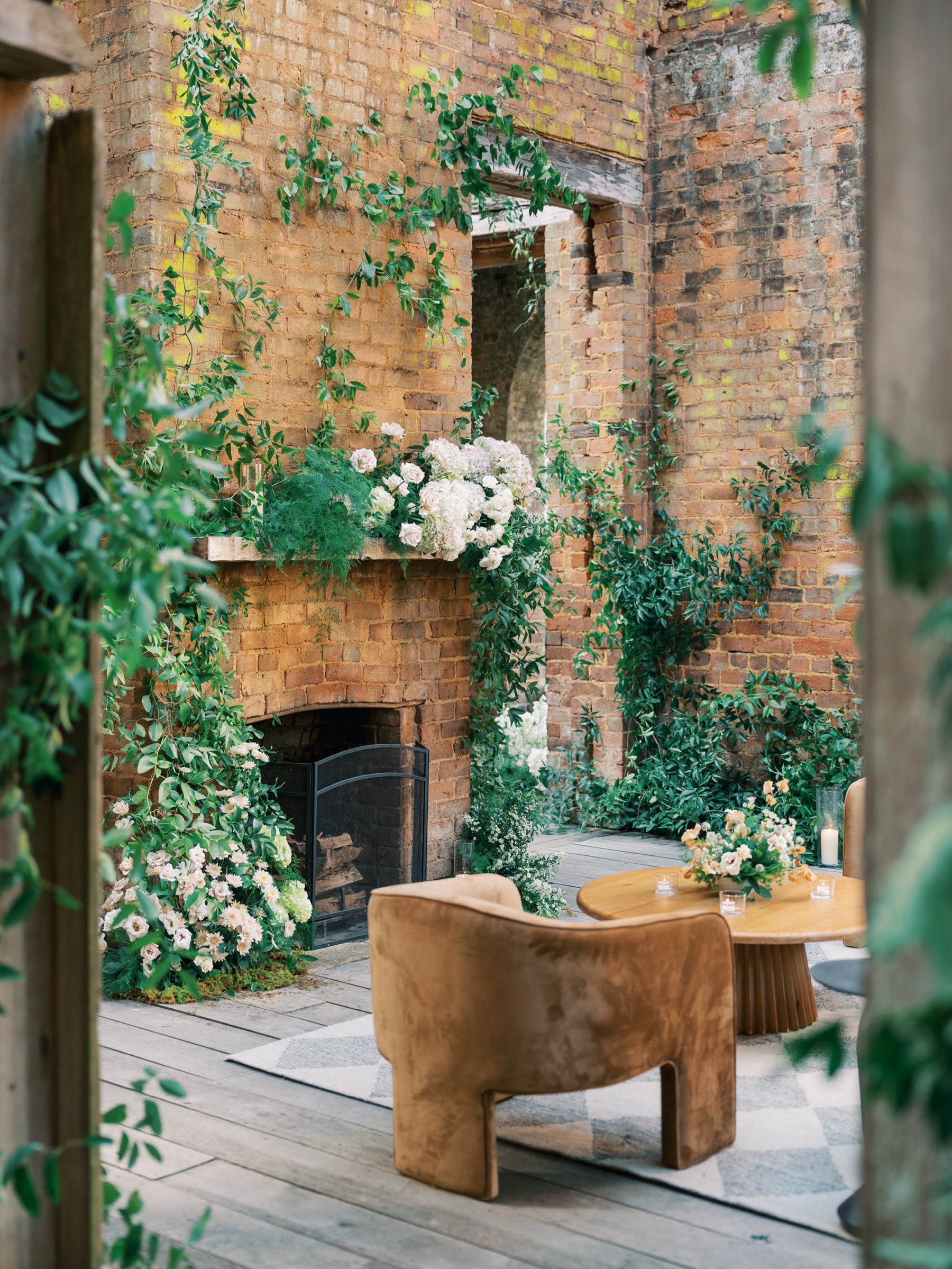 Inside the ruins - decorated fireplace, flowers, and seating area