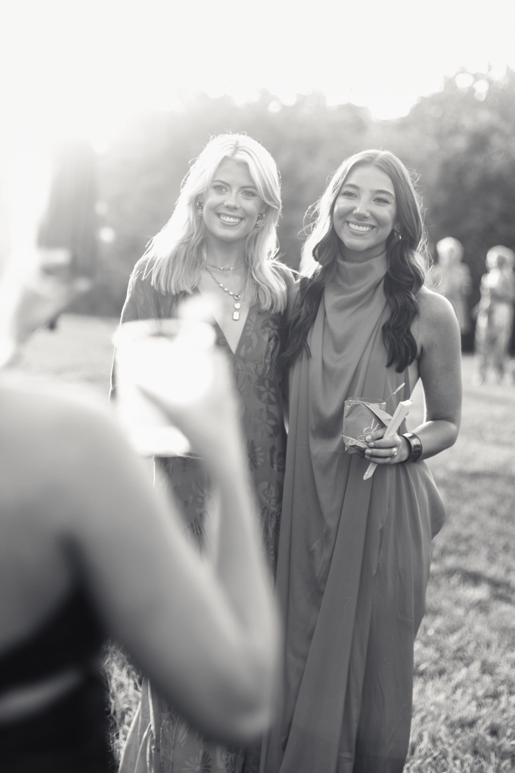 guests smiling at camera during cocktail hour of north carolina family farm wedding