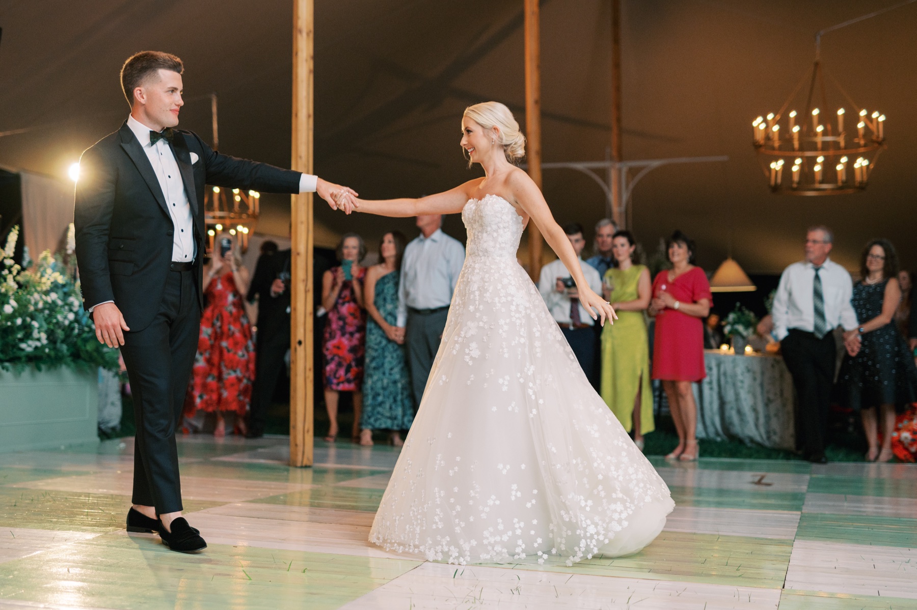 bride and groom during their first dance inside tented reception 