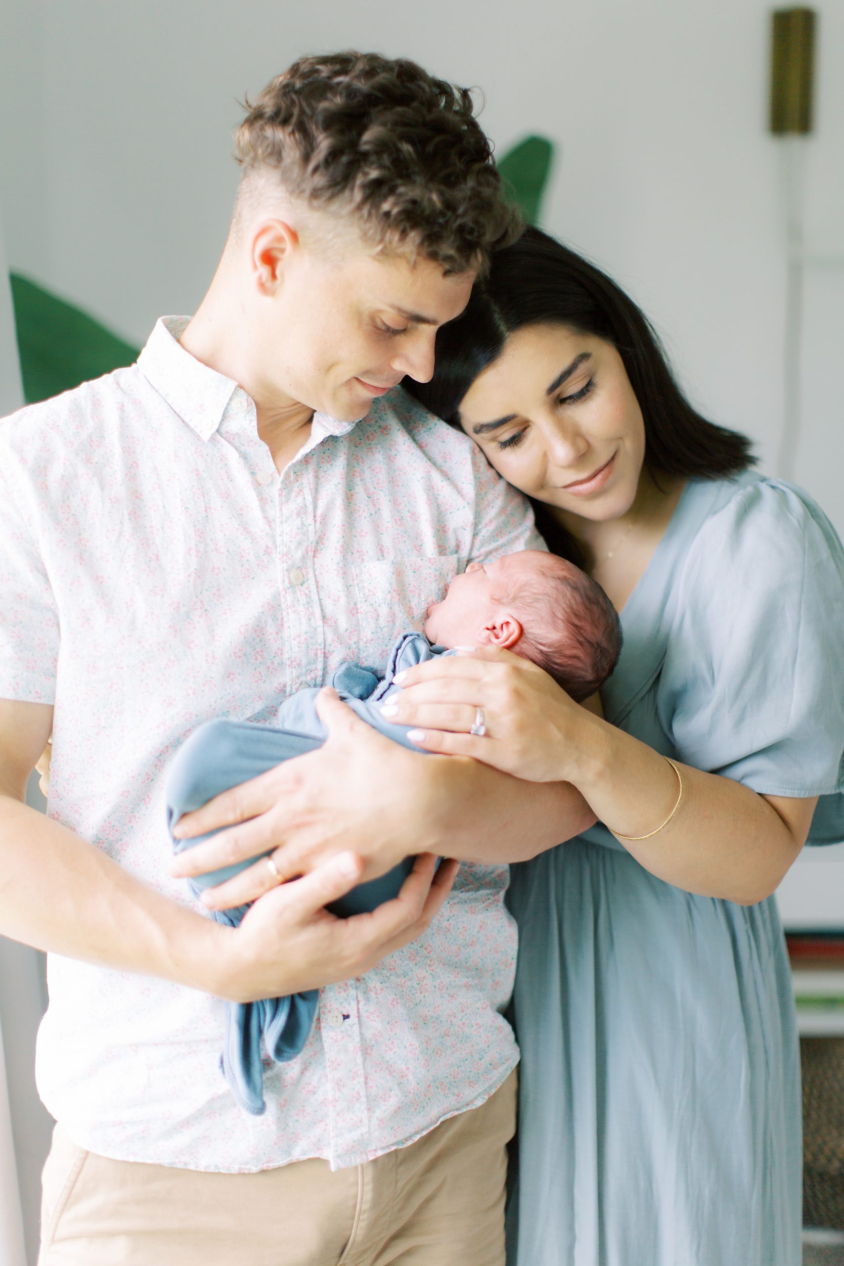 mom and dad hold baby boy during lifestyle portraits at home