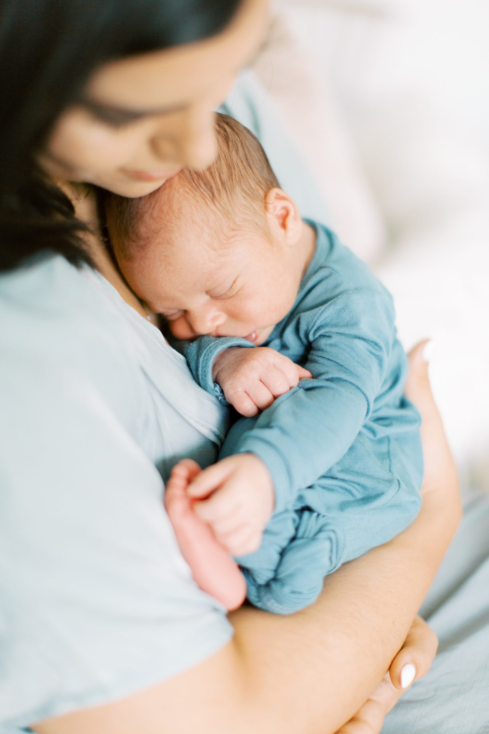 Charlotte lifestyle newborn session with newborn baby boy in blue wrap