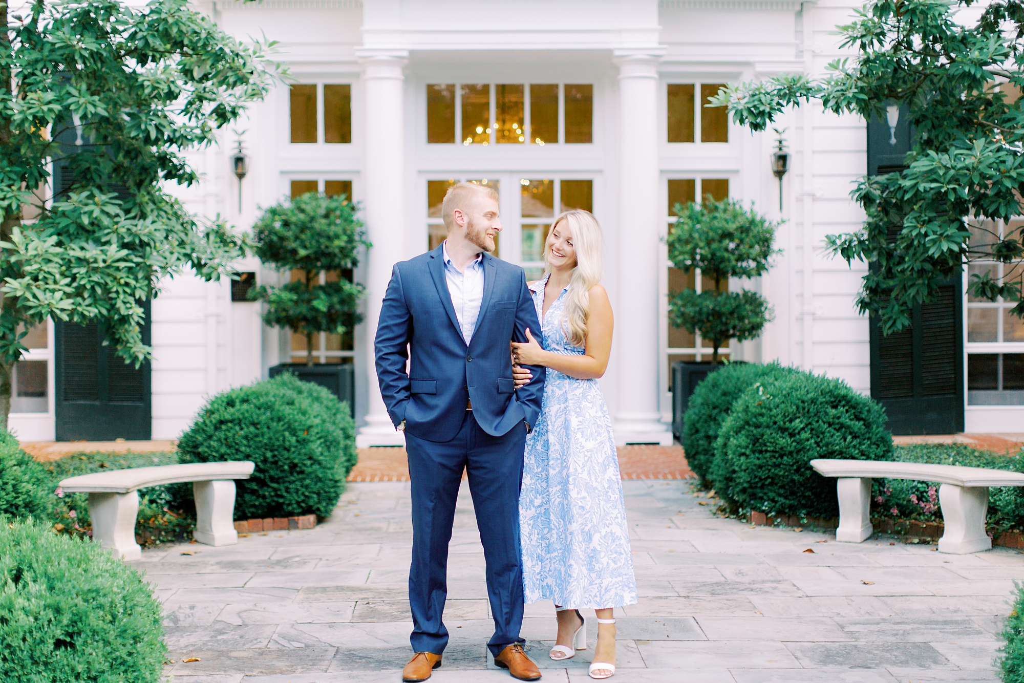 engaged couple in blue suit and blue dress pose during Duke Mansion engagement session