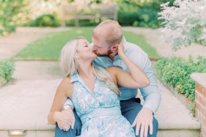 engaged couple kisses on steps during Duke Mansion engagement session