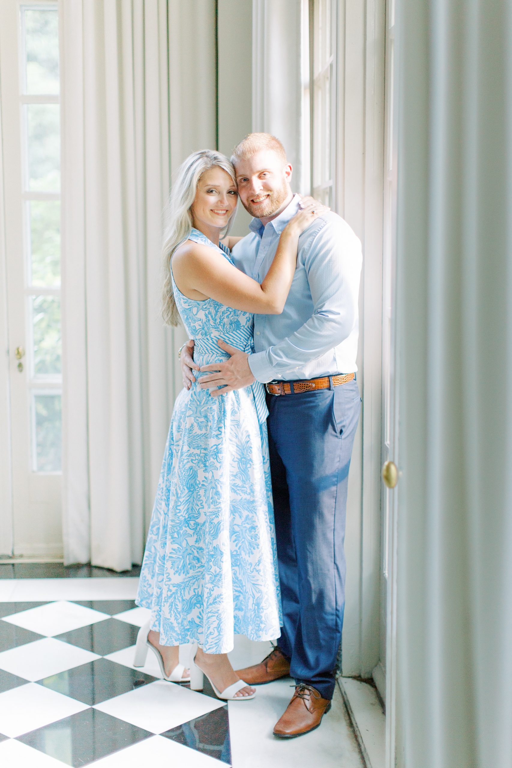 engaged couple poses inside Duke Mansion