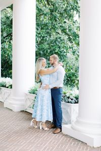 bride and groom pose on porch of Duke Mansion