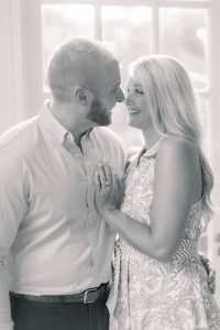 engaged couple laughs together during Duke Mansion engagement session