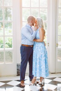 groom leans to kiss bride inside Duke Mansion
