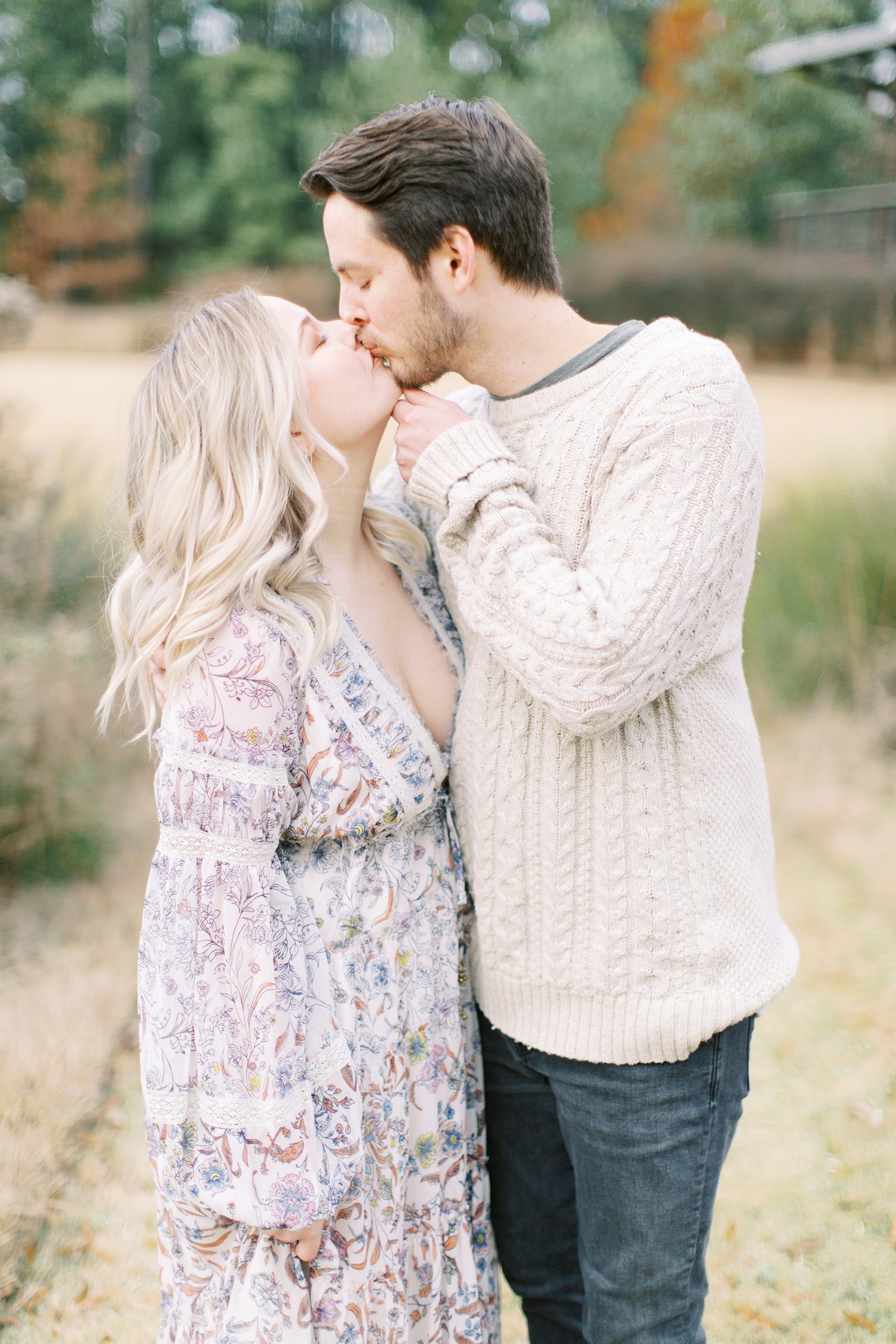 groom kisses fiancee during engagement photos
