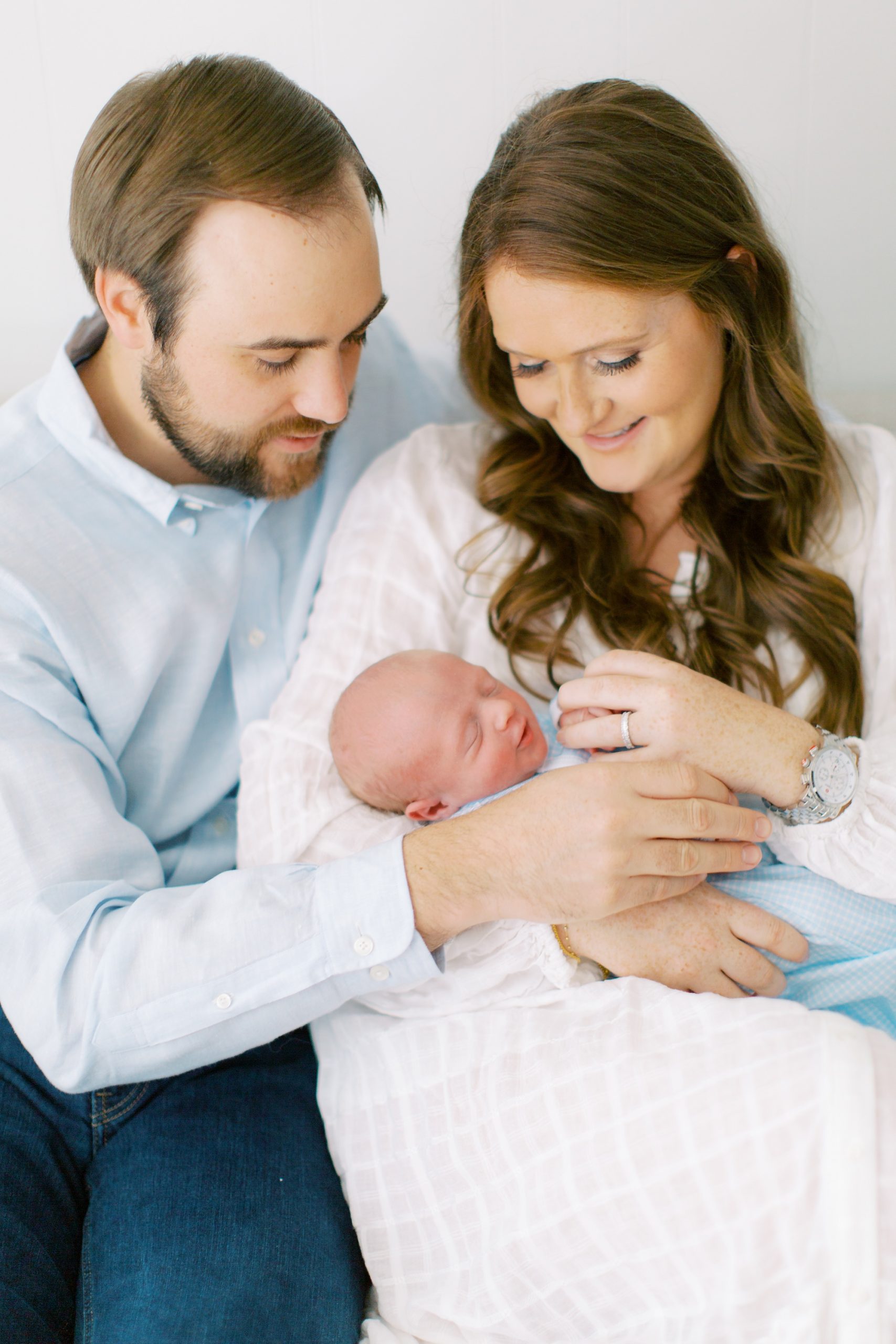 new parents hold baby boy during lifestyle photos at home