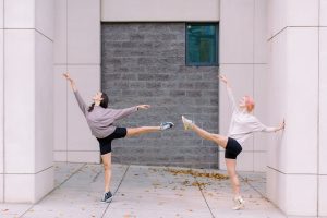 dancers hold arabesques during Uptown Charlotte Branding Session