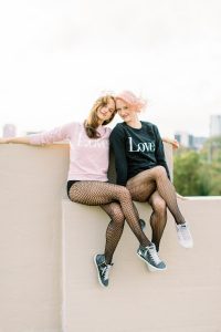 Uptown Charlotte Branding Session of two dancers sitting on rooftop of parking deck
