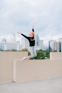 dancer jumps off edge of parking deck during Uptown Charlotte Branding Session
