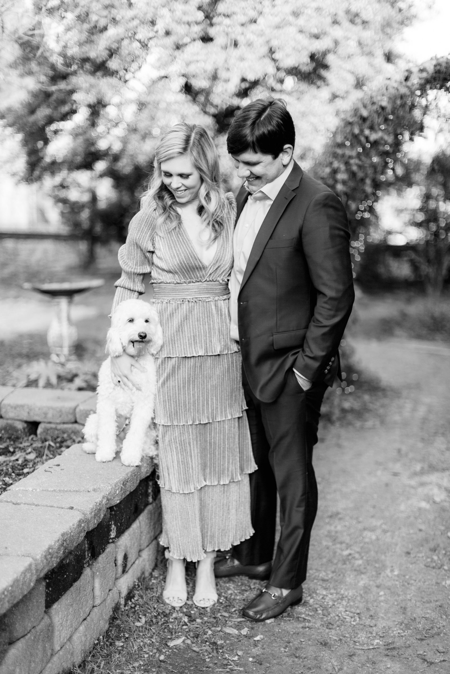 couple poses with their half poodle dog during anniversary portraits