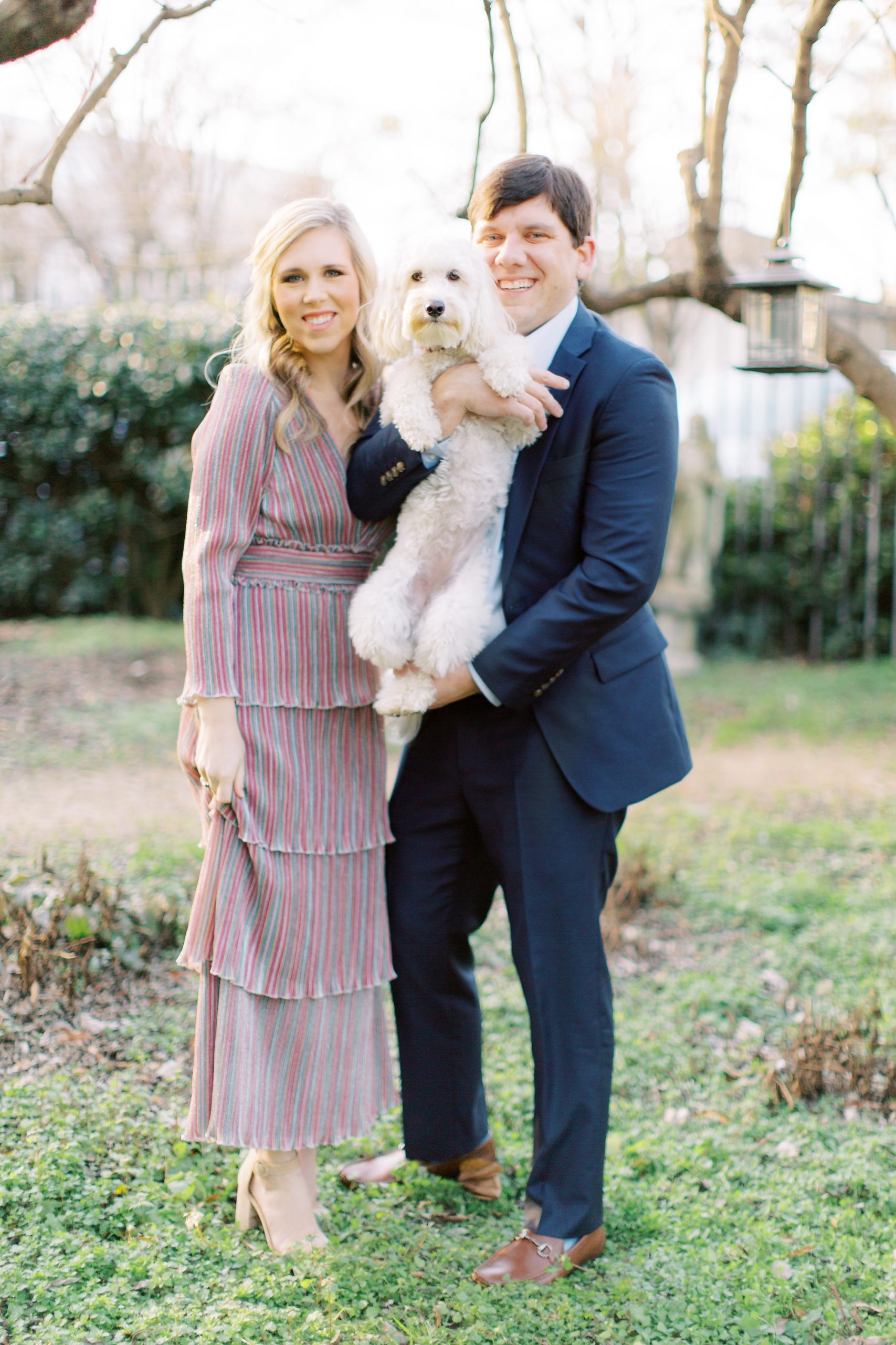 married couple holds puppy dog during McGill Rose Garden Anniversary Session