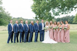 bride and groom pose with full bridal party at The Dairy Barn