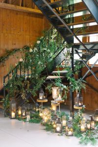 greenery around staircase leading to ceremony at The Dairy Barn