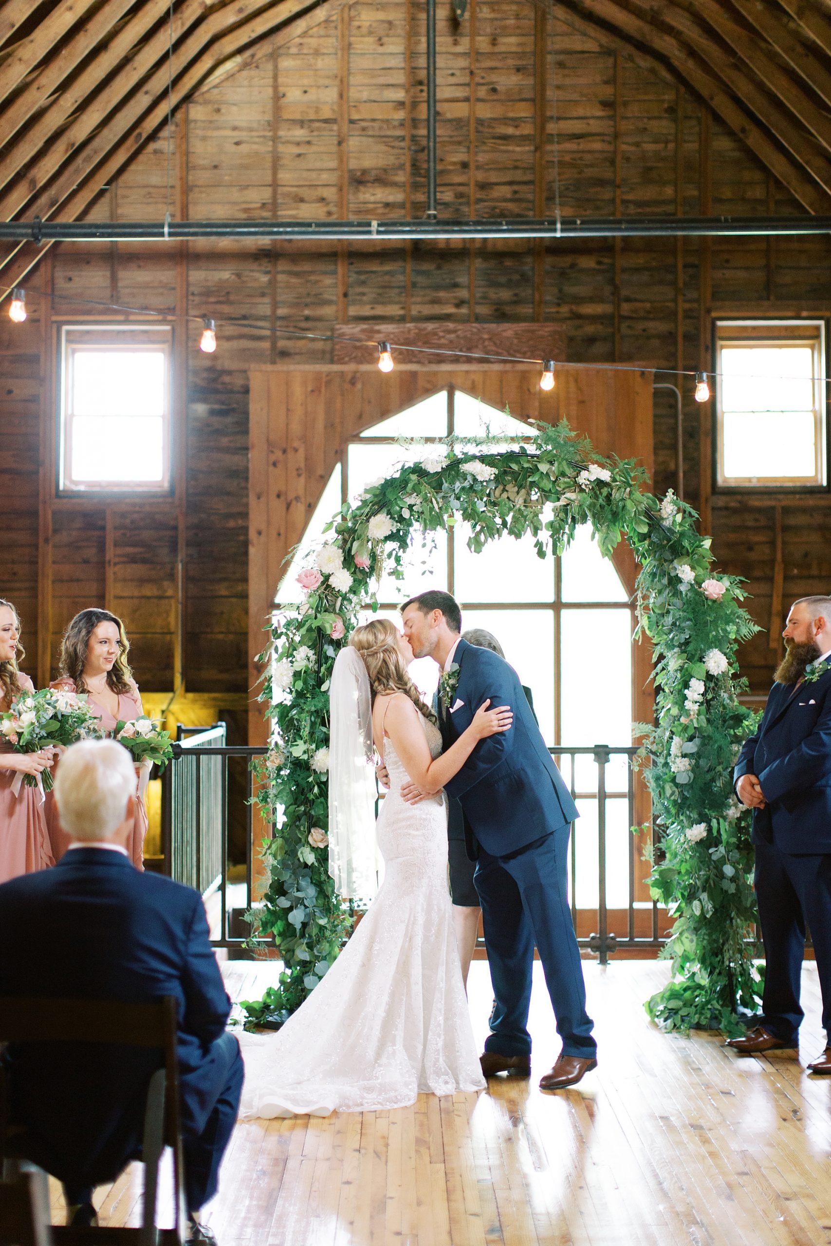 groom kisses bride during The Dairy Barn wedding ceremony