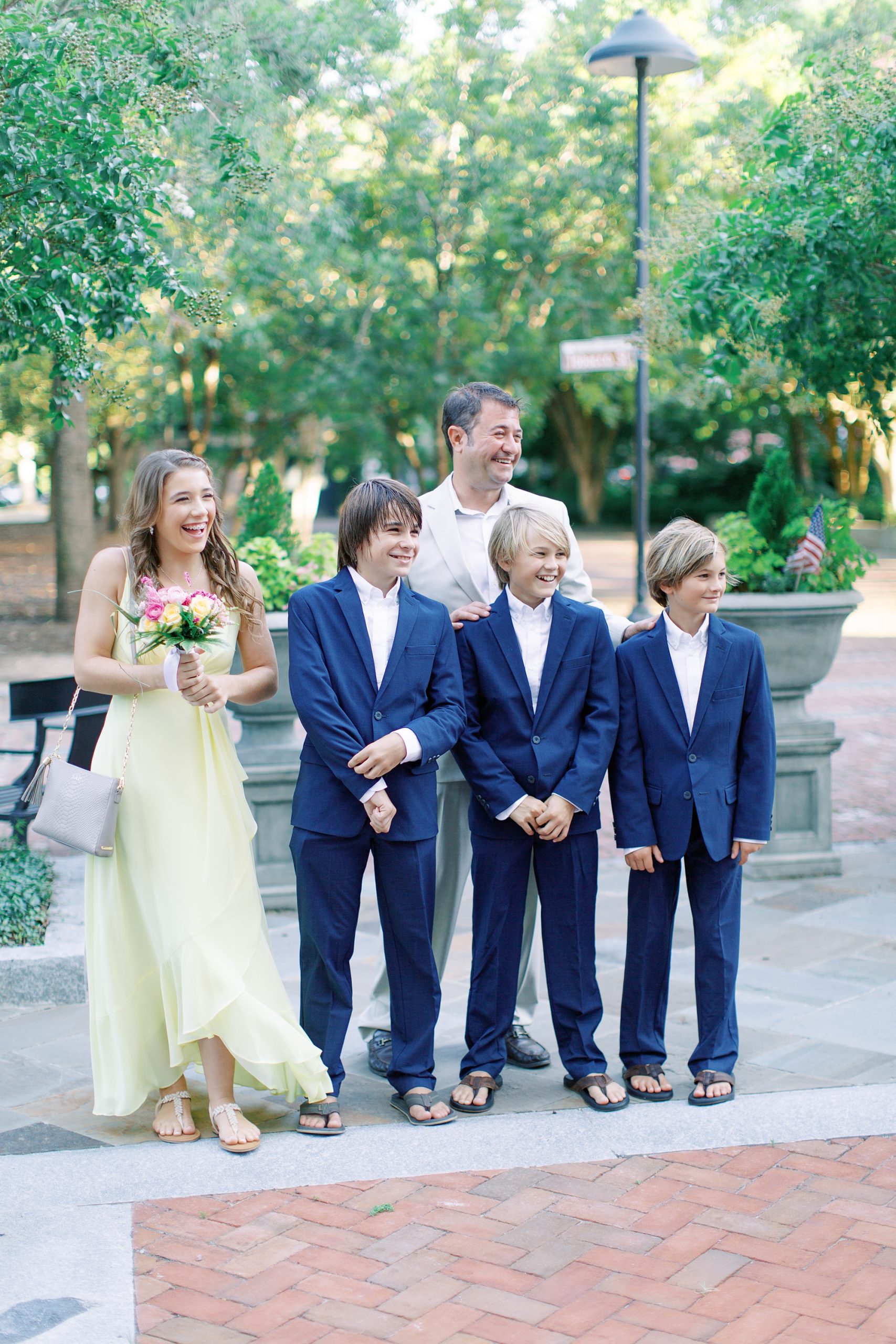 groom and four children watch bride leave Charleston hotel