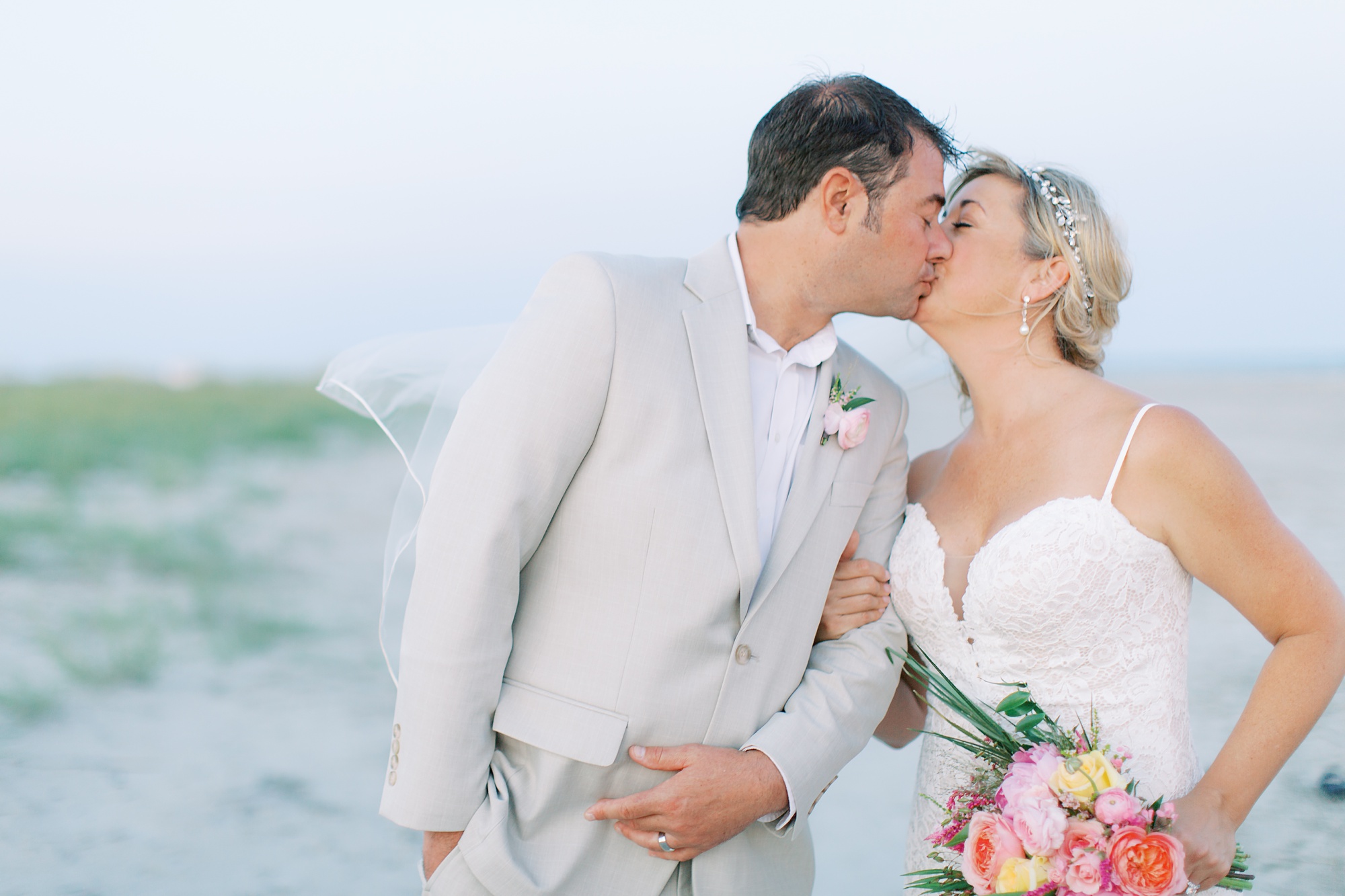 newlyweds kiss on beach in Sullivan's Island