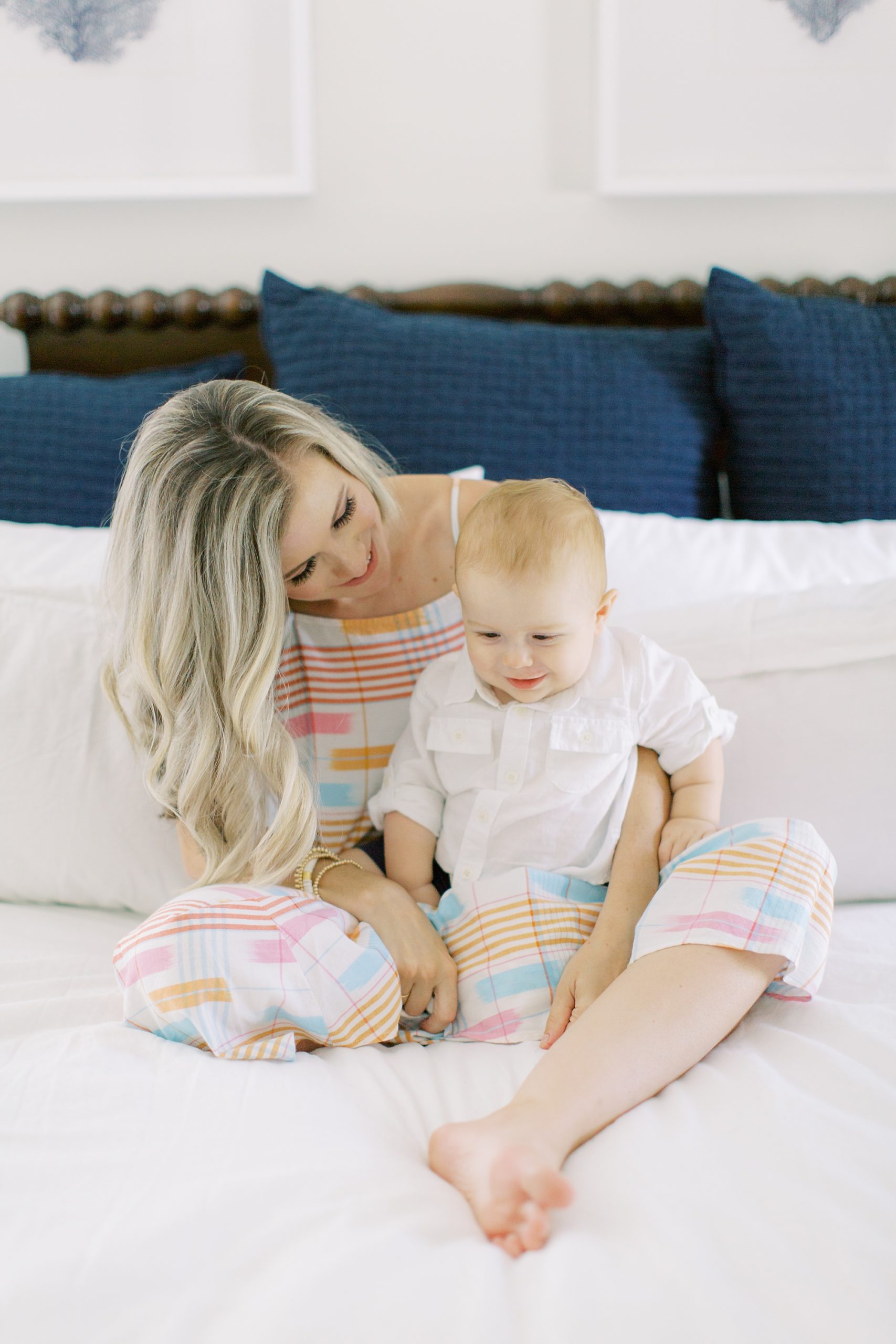 mom and son pose on bed during Charlotte Family Session