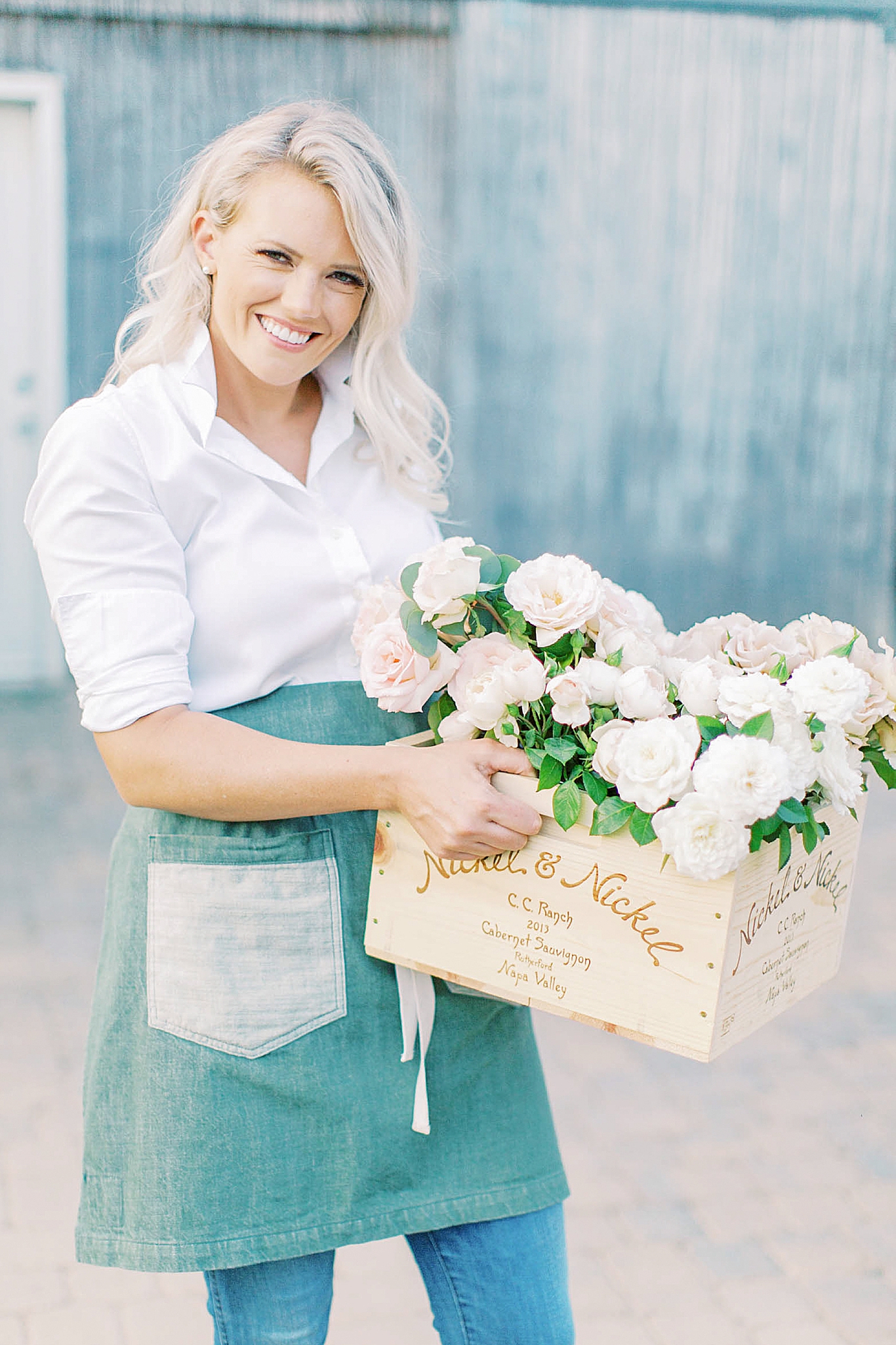florist hold wooden box of ivory flowers
