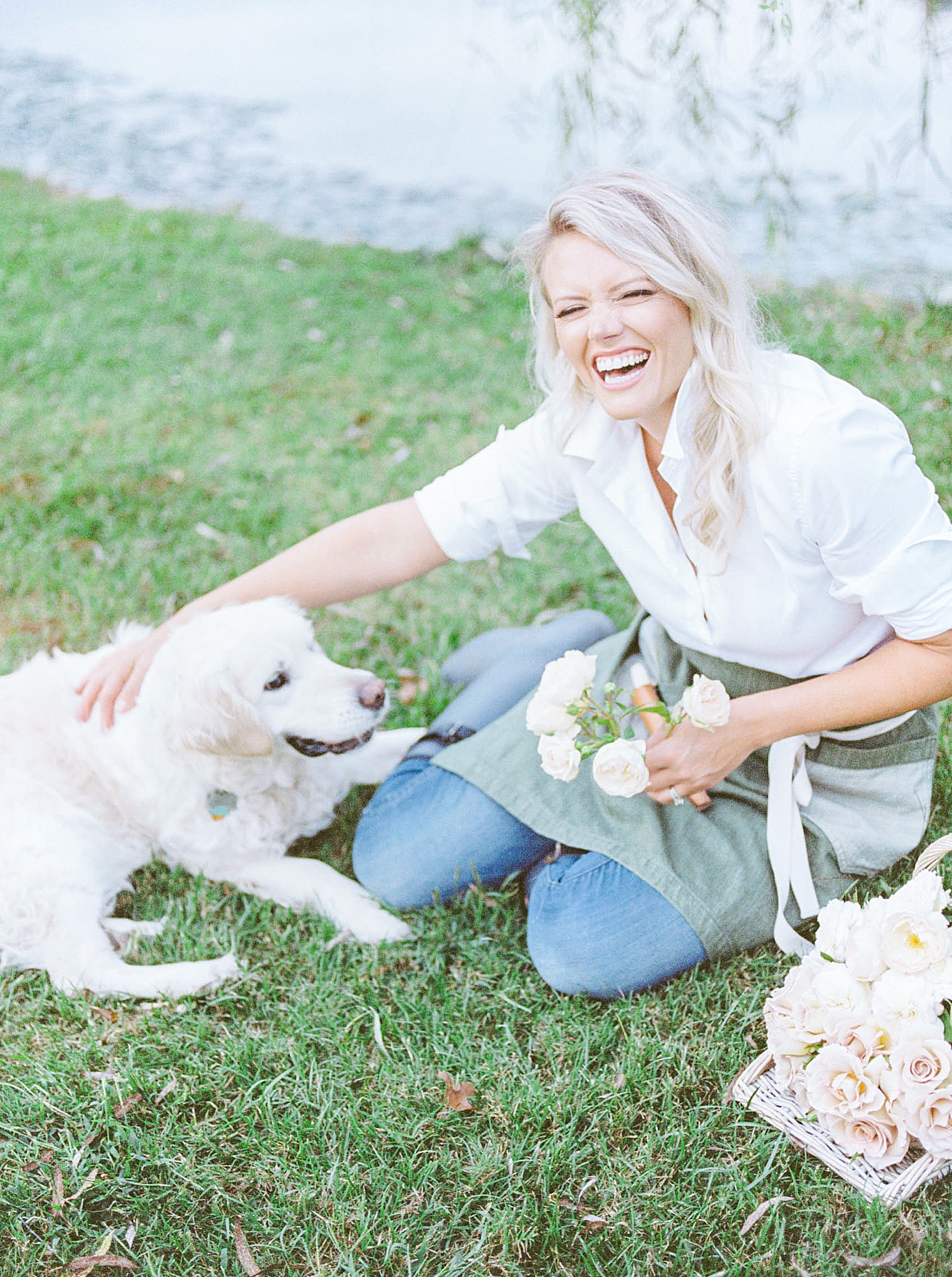 florist laughs with dog during branding photos at Morning Glory Farm