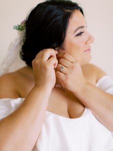 bride adjusts earrings before SC wedding