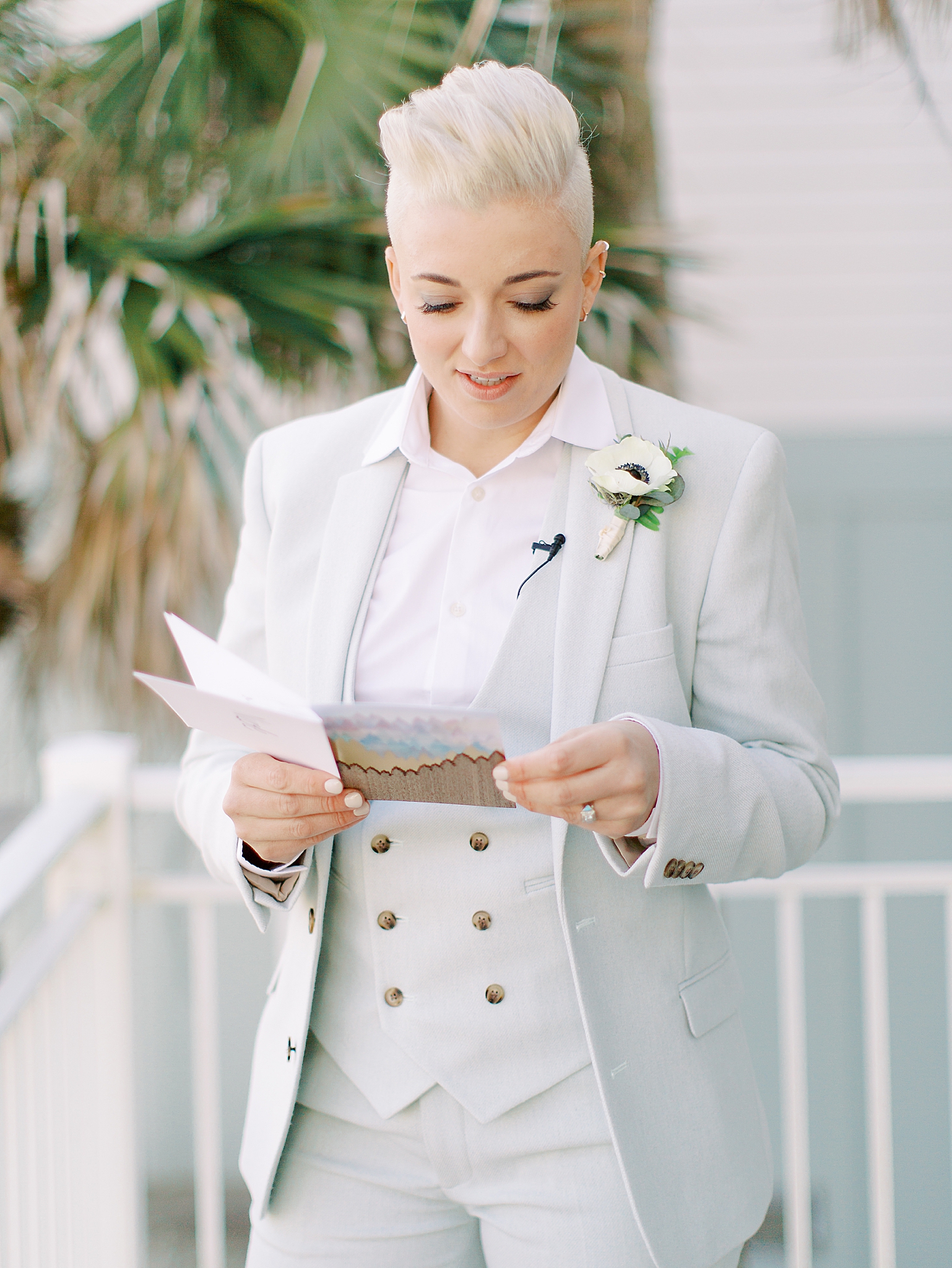 bride reads letter before SC wedding on the beach