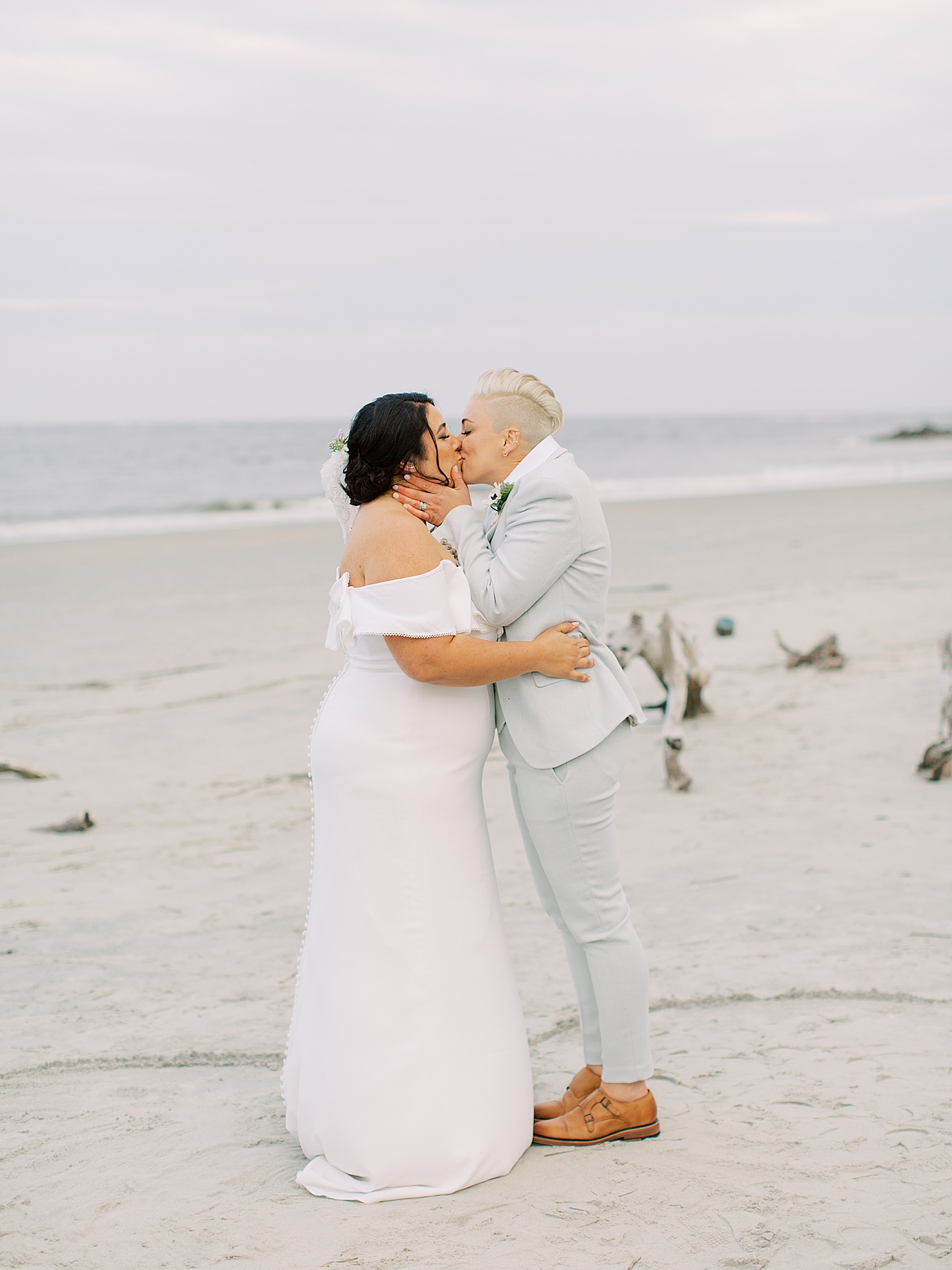partners kiss during wedding ceremony on the beach