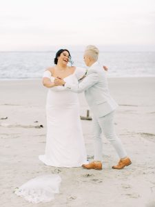 couple dances on beach in Charleston after wedding ceremony